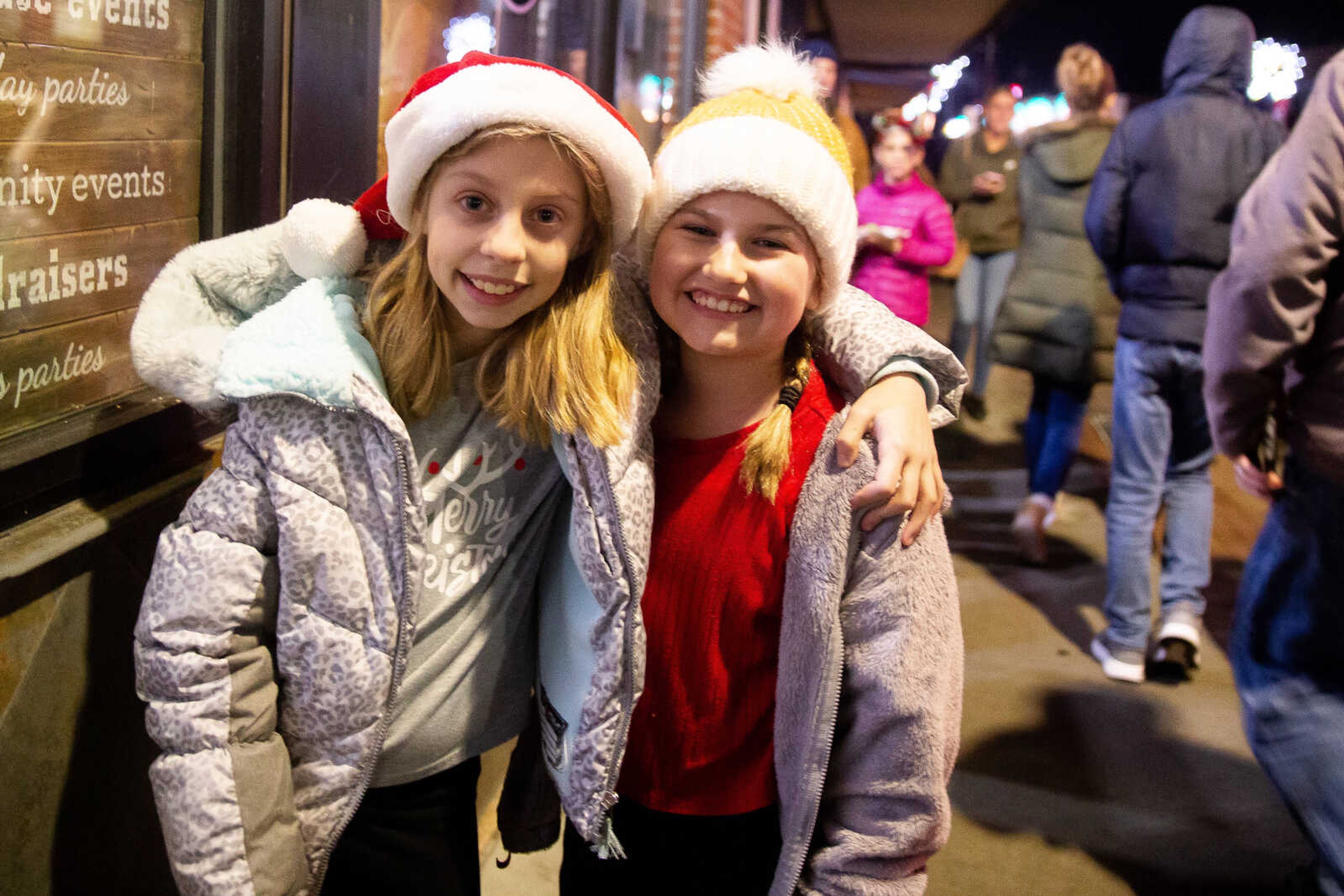 Leah Bennett and Chloe Keys, both 9, pose together after caroling with their school choir&nbsp;on Friday, Dec. 2 in downtown Cape Girardeau.