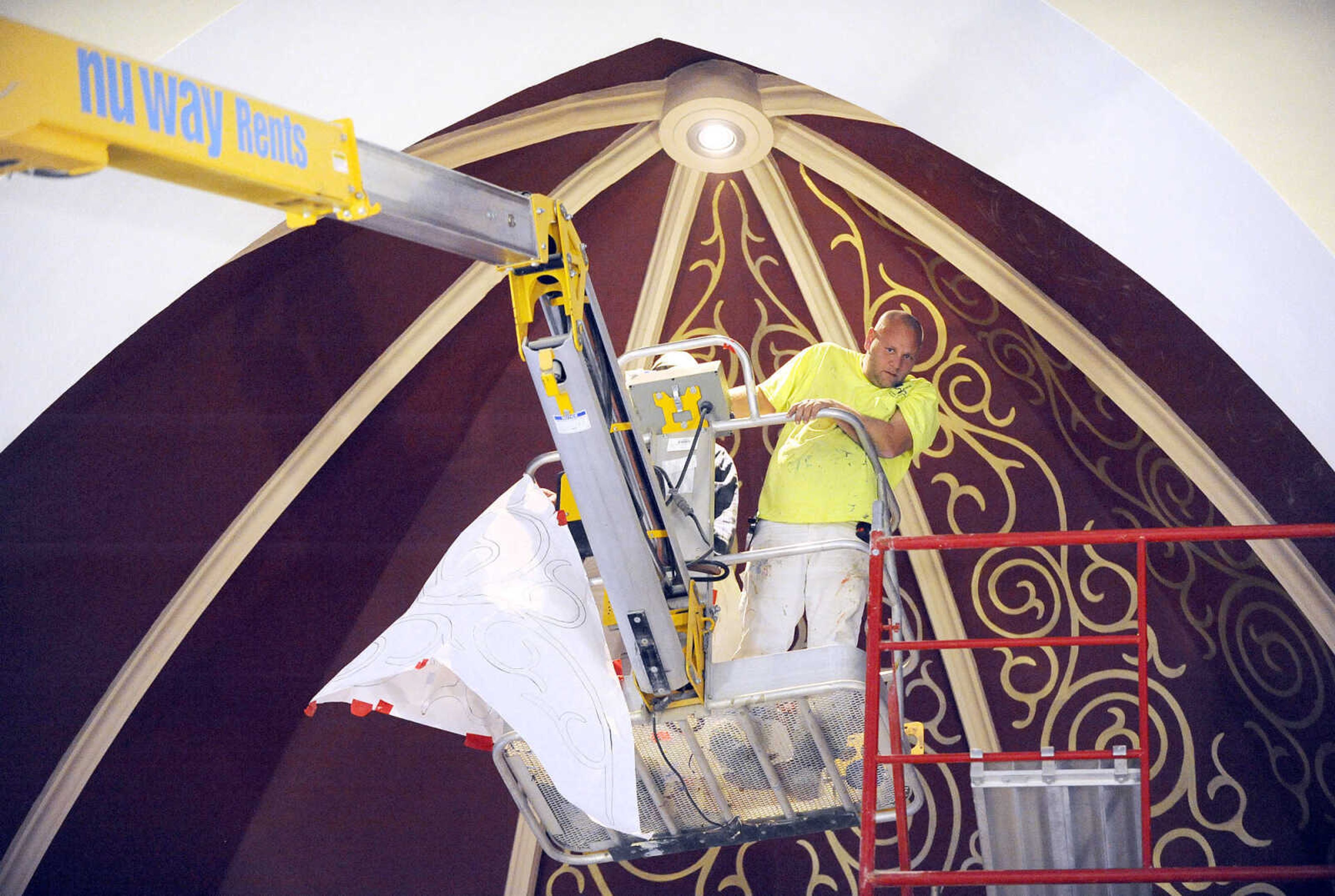 LAURA SIMON ~ lsimon@semissourian.com

Gary West, left, and Roy Diamond make their way to the ceiling above the altar in a cherry picker to work on the stenciling at St. John's Catholic Church in Leopold, Missouri.