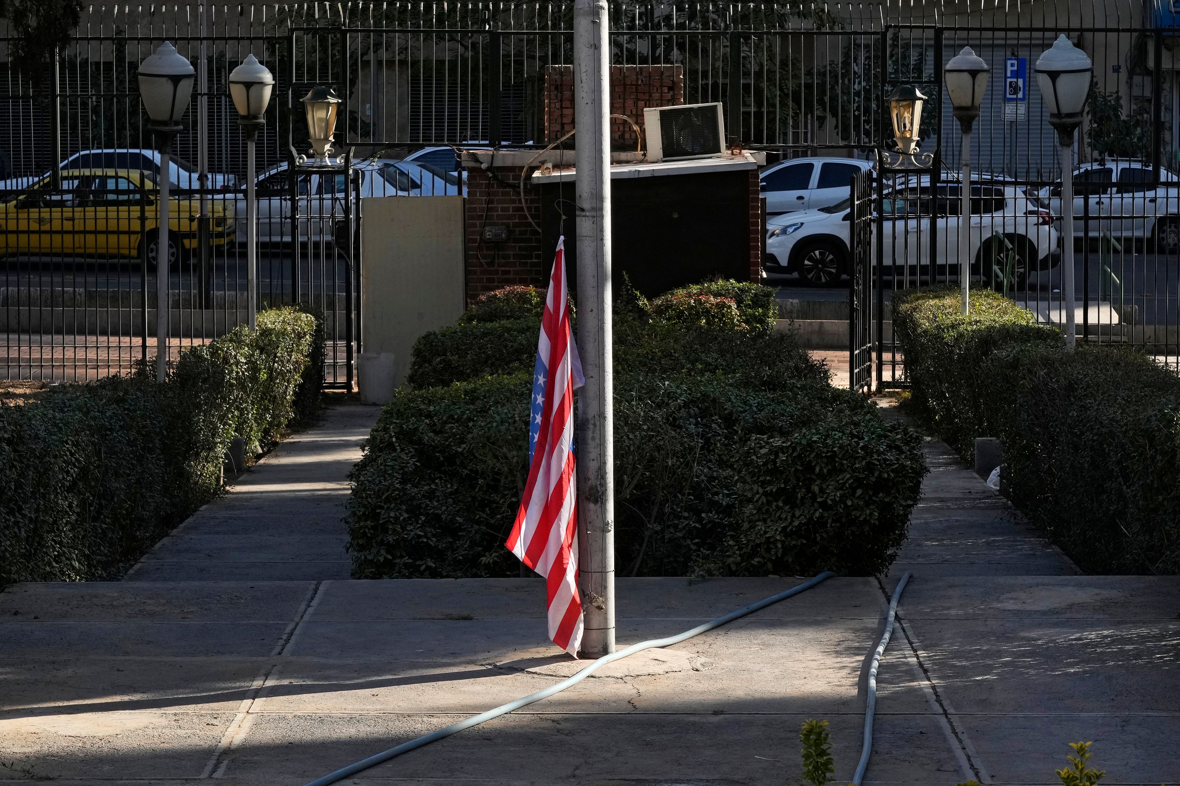 A U.S. flag is placed under a flagpole at the former U.S. Embassy, which has been turned into an anti-American museum, in Tehran, Iran, Tuesday, Oct. 22, 2024. (AP Photo/Vahid Salemi)