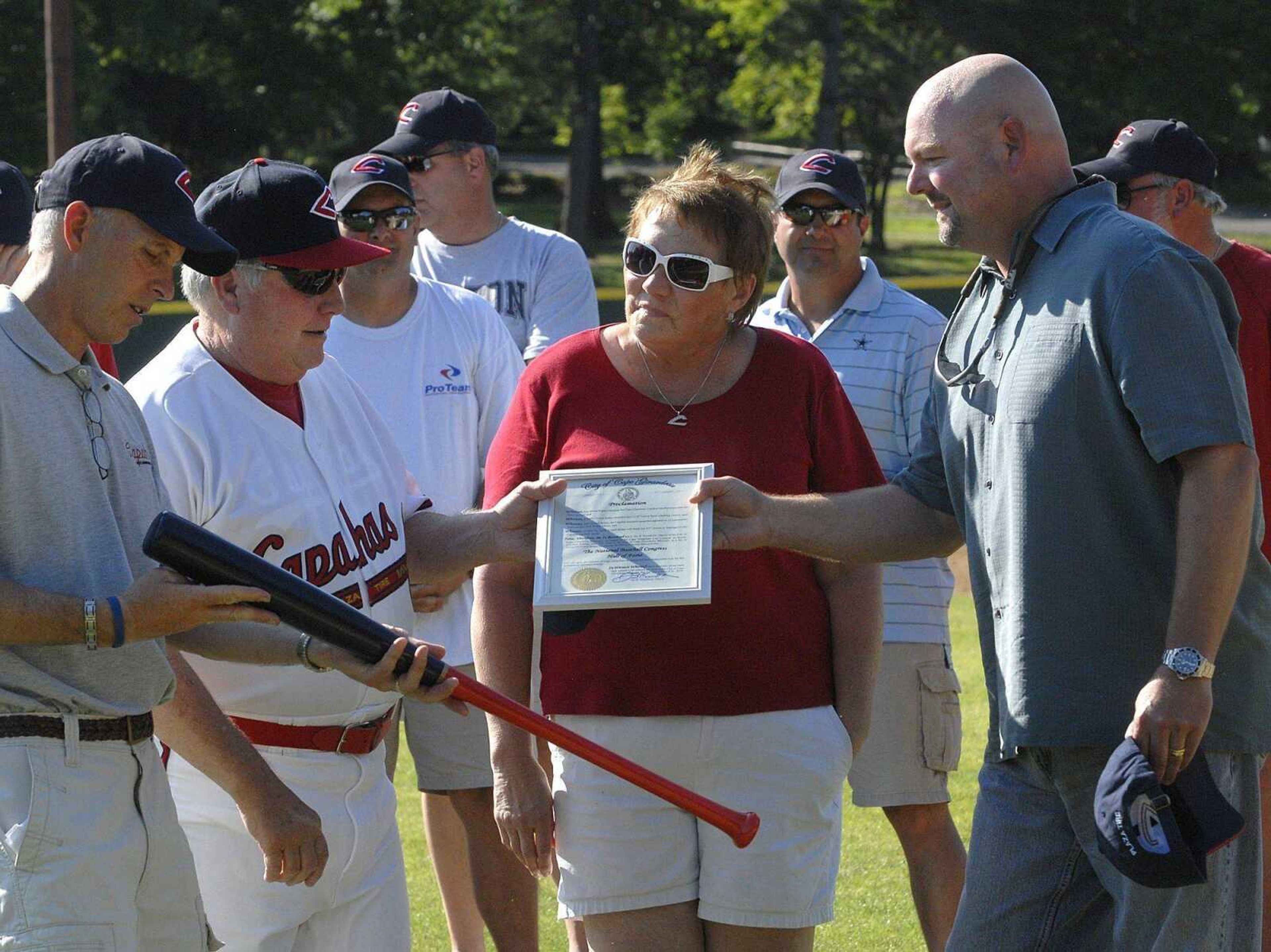 Capahas manager Jess Bolen receives a proclamation from Cape Girardeau Mayor Jay Knudtson, right, during a ceremony before Sunday's game. Bolen stands with his wife, Mary.