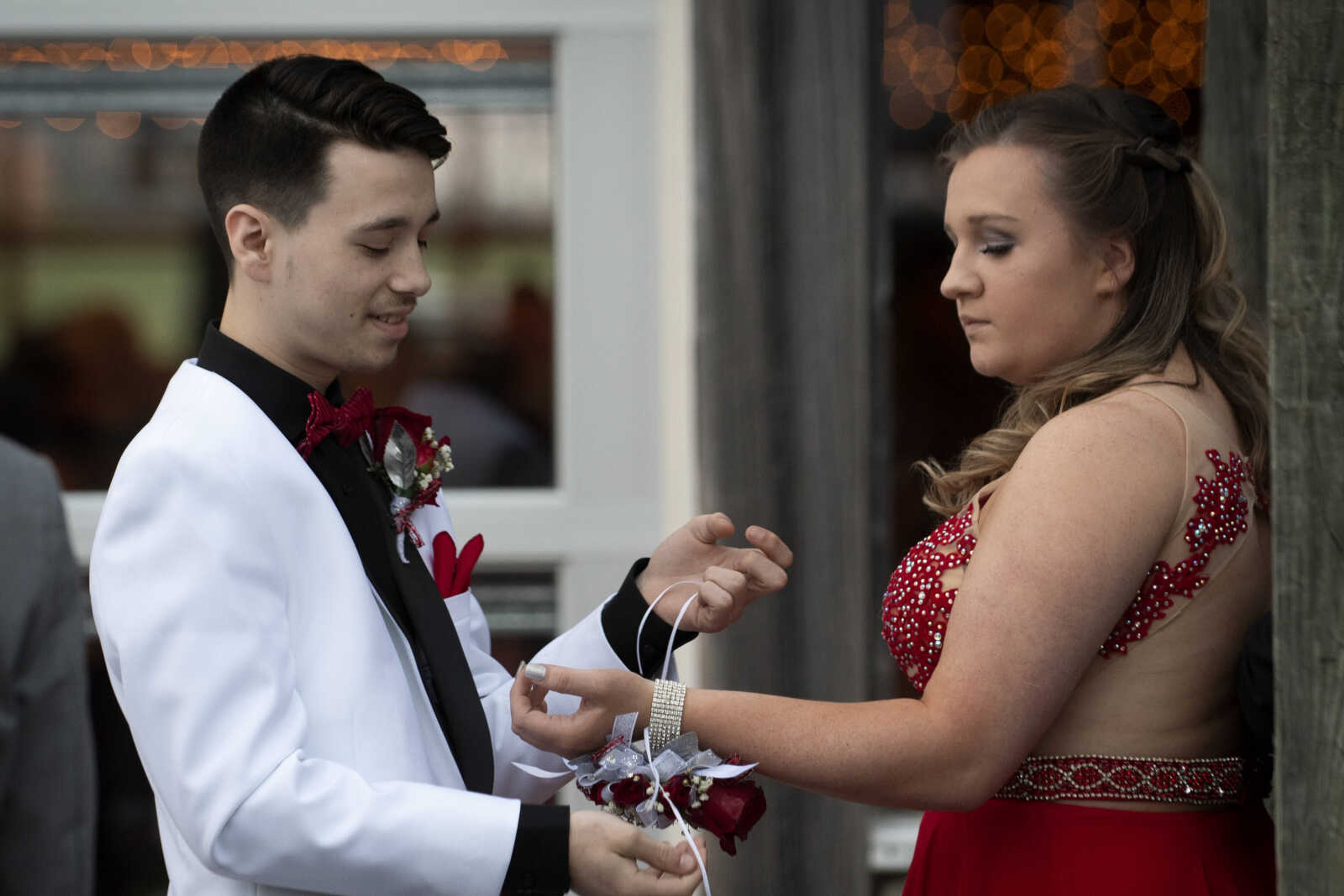 Tristden Smith adjusts the corsage of Scott City junior Alyssa McFall during Scott City's prom Saturday, April 6, 2019, at Deerfield Lodge in Cape Girardeau.