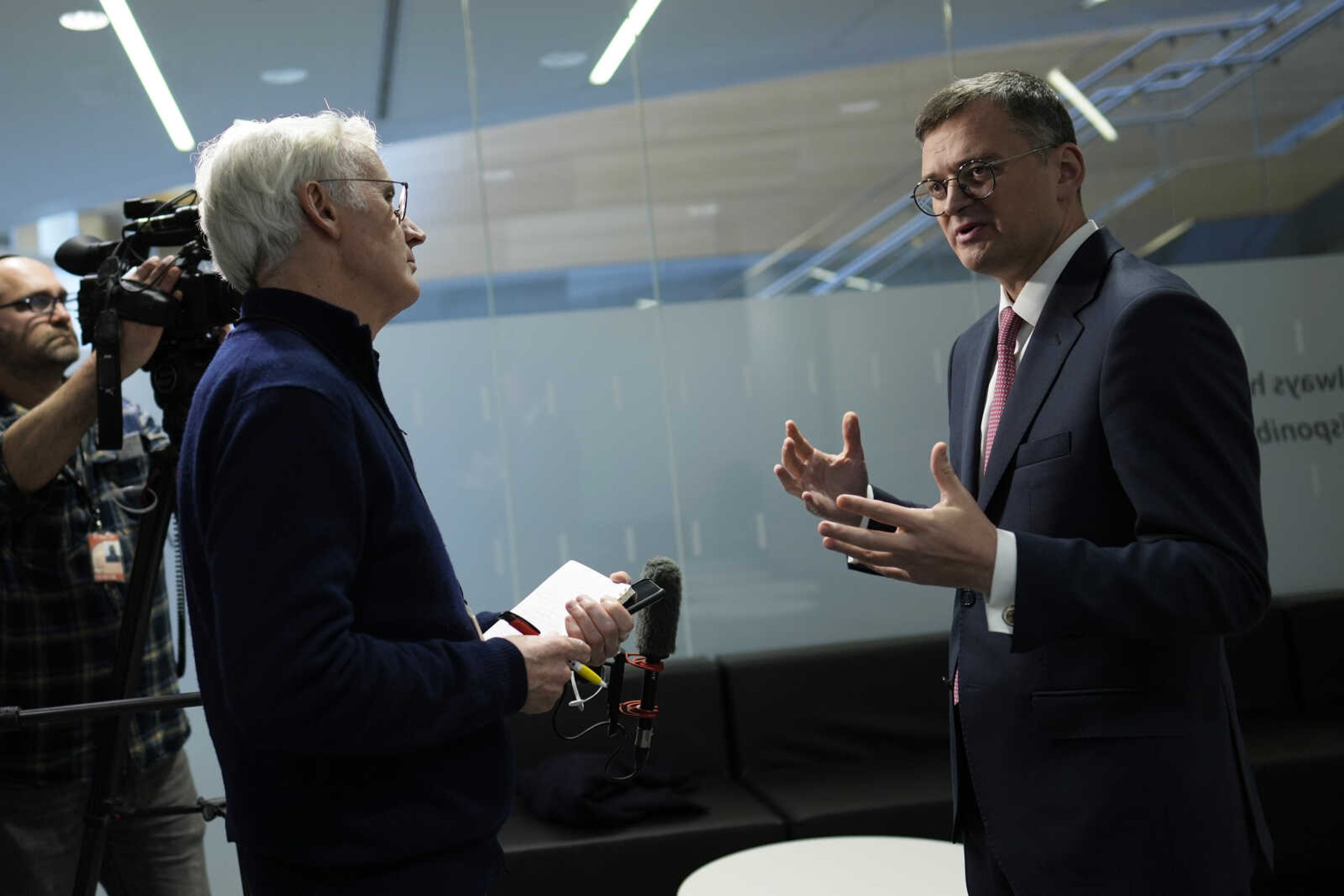 Ukraine's Foreign Minister Dmytro Kuleba, right, speaks during an interview at NATO headquarters Wednesday in Brussels.