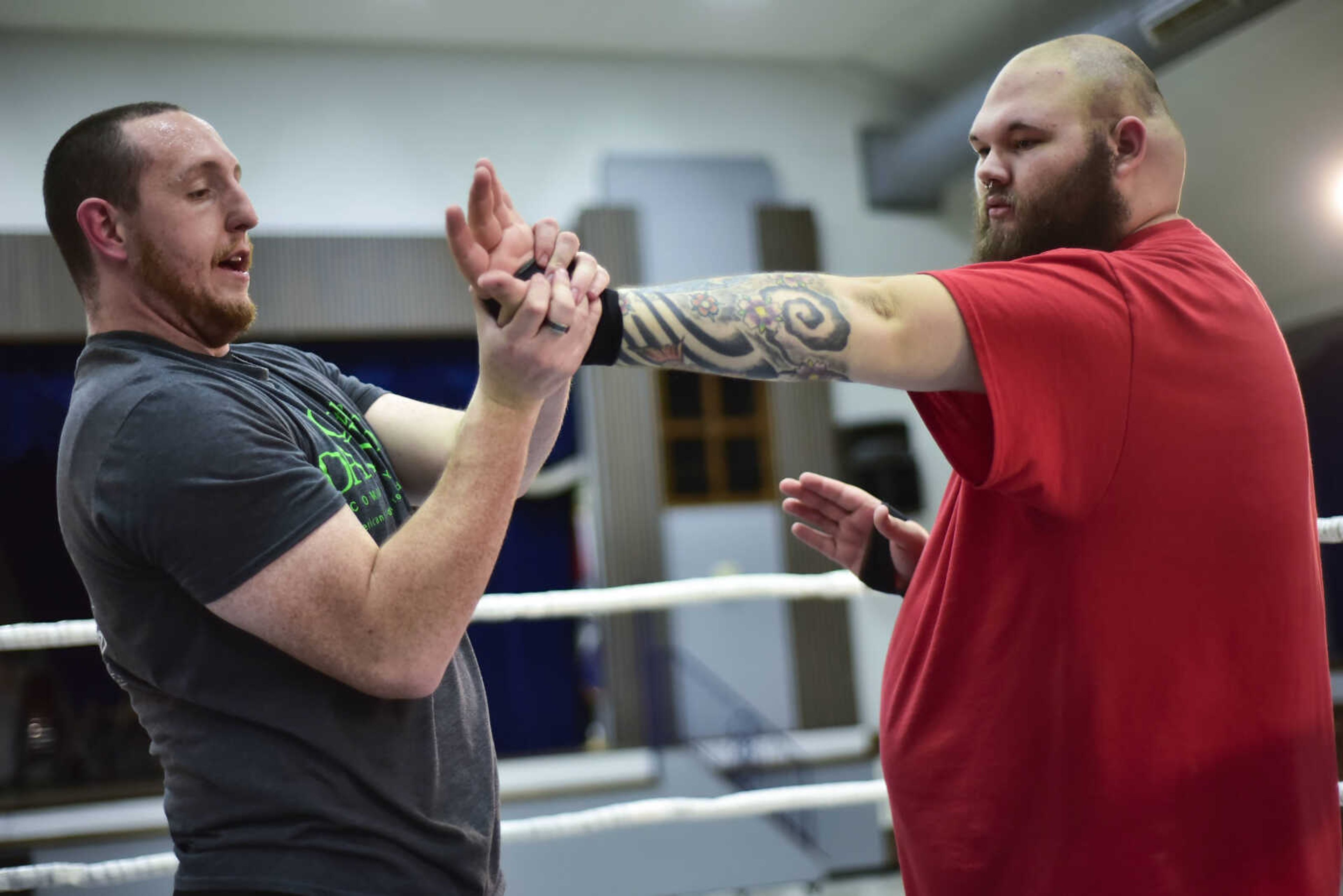 CCW wrestler Brandon "Barbwire" Anderson, left, helps Donald "Big Nasty" Vogler improve his wrestling technique before a One Night Riot event Saturday, Feb. 24, 2018, at the Arena Building in Cape Girardeau.