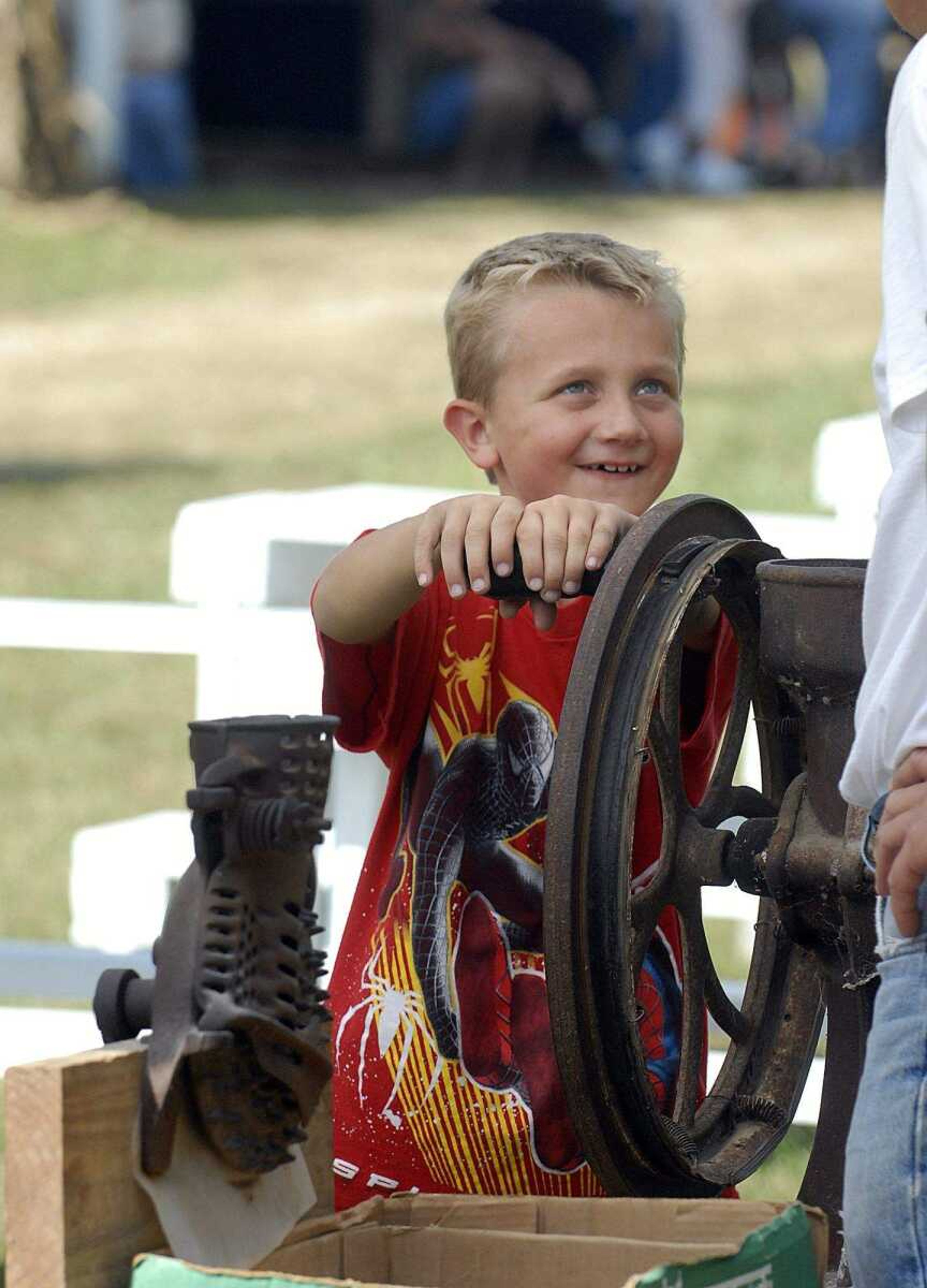 ELIZABETH DODD ~ edodd@semissourian.com
Jacob Barks, 7, of Sedgewickville, learns how to grind corn at the Black Forest Villages 18th Annual October Fest Saturday.