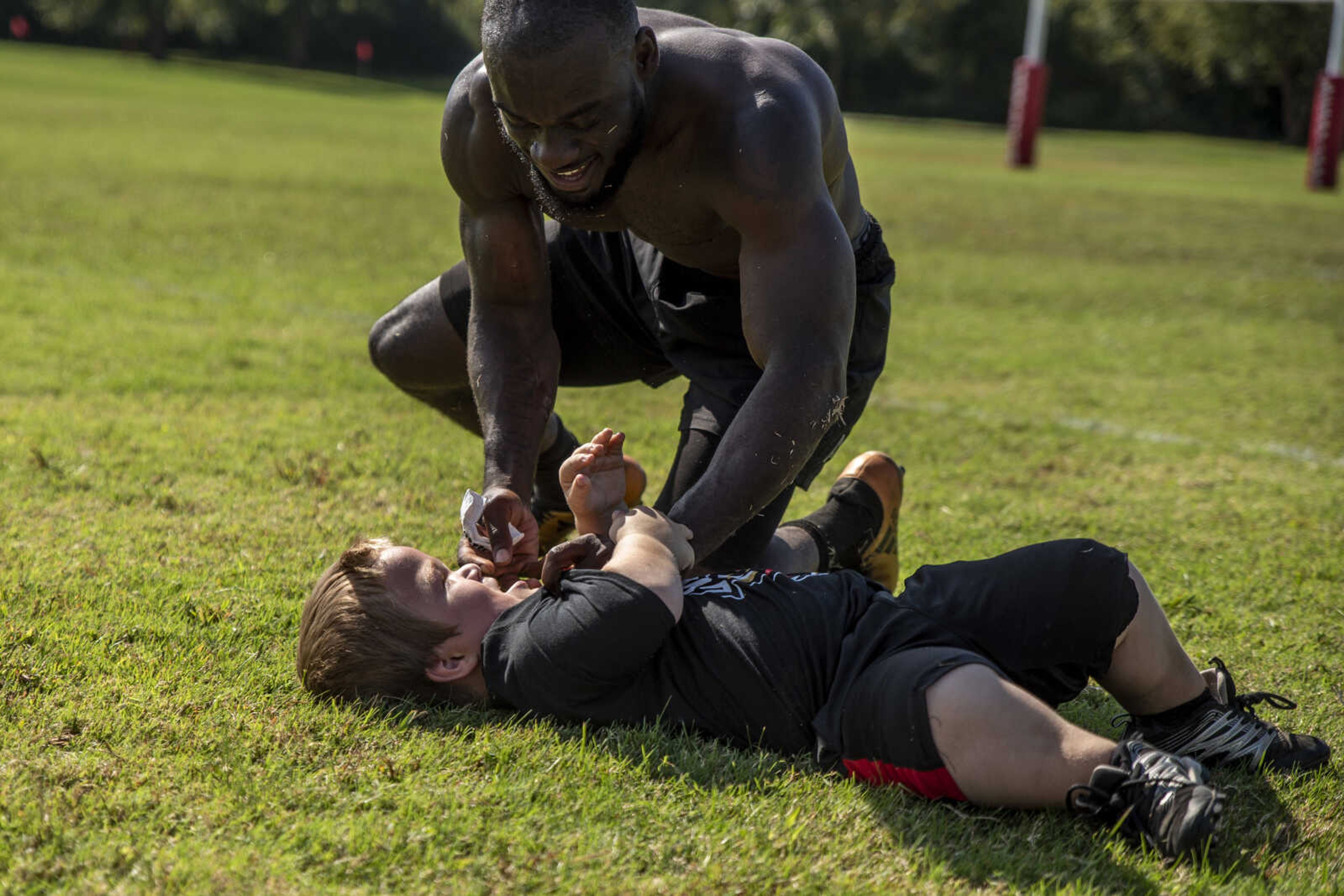 Kweku Arkorful play wrestles with Izaac Pursley after a Kohlfeld Scorpions Rugby Club game Oct. 6, 2018, in Cape Girardeau.