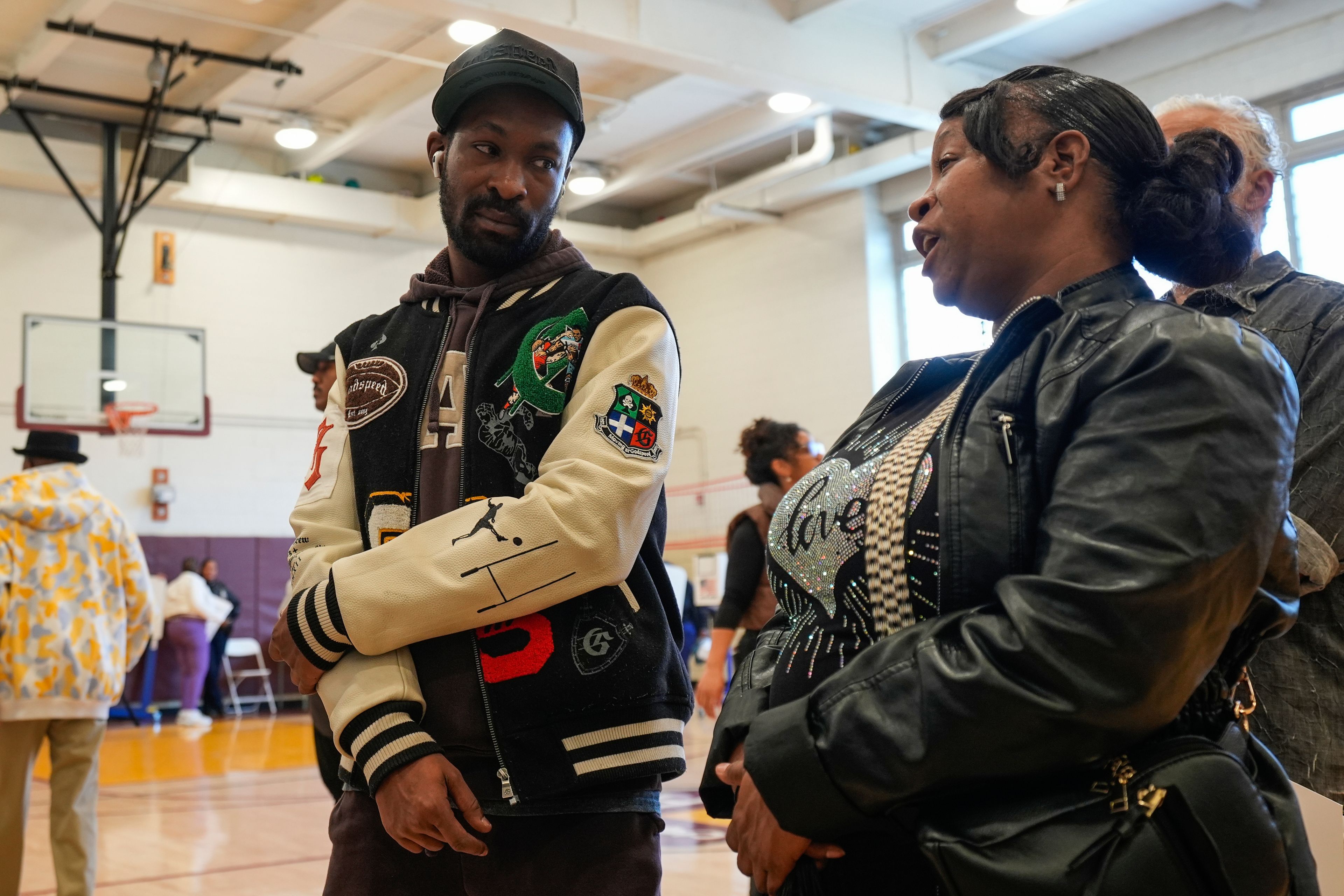 Tanisha Jacobis, right, stands in line with her son Farris Jones, left, to cast their ballots at the P.S. 175 Henry Highland Garnet school on Election Day, Tuesday, Nov. 5, 2024, in New York. (AP Photo/Frank Franklin II)