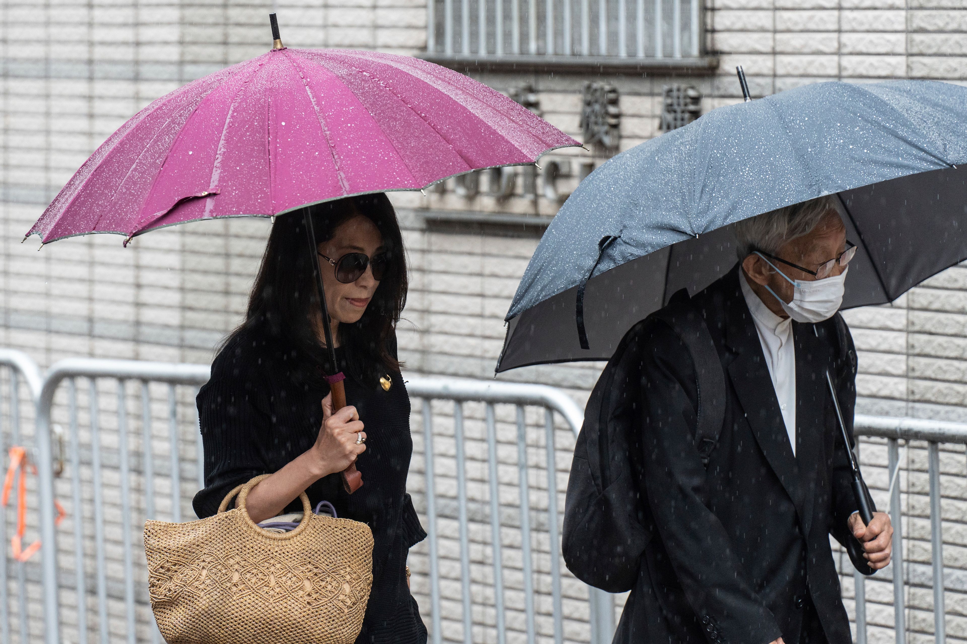 Jimmy Lai's wife Teresa Lai, left, and retired Chinese cardinal Joseph Zen Ze-Kiun arrive at West Kowloon Magistrates' Courts to attend Hong Kong activist publisher Lai's national security trial in Hong Kong, Wednesday, Nov. 20, 2024. (AP Photo/Chan Long Hei)