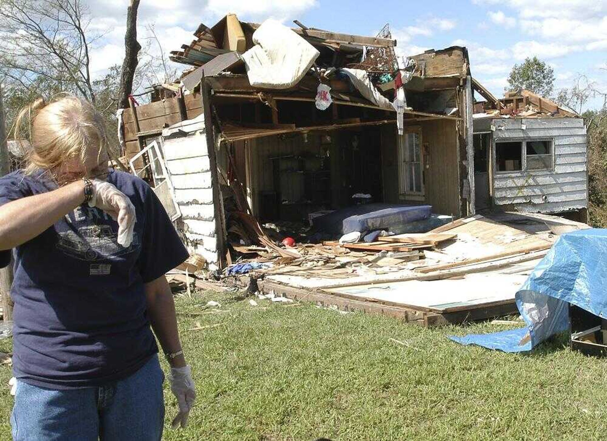 Debra Schultz wiped sweat from her face on Sept. 25, 2006, while looking for her belongings among the debris left of her Crosstown home after a tornado destroyed it. (DIANE L. WILSON ~ dlwilson@semissourian.com)