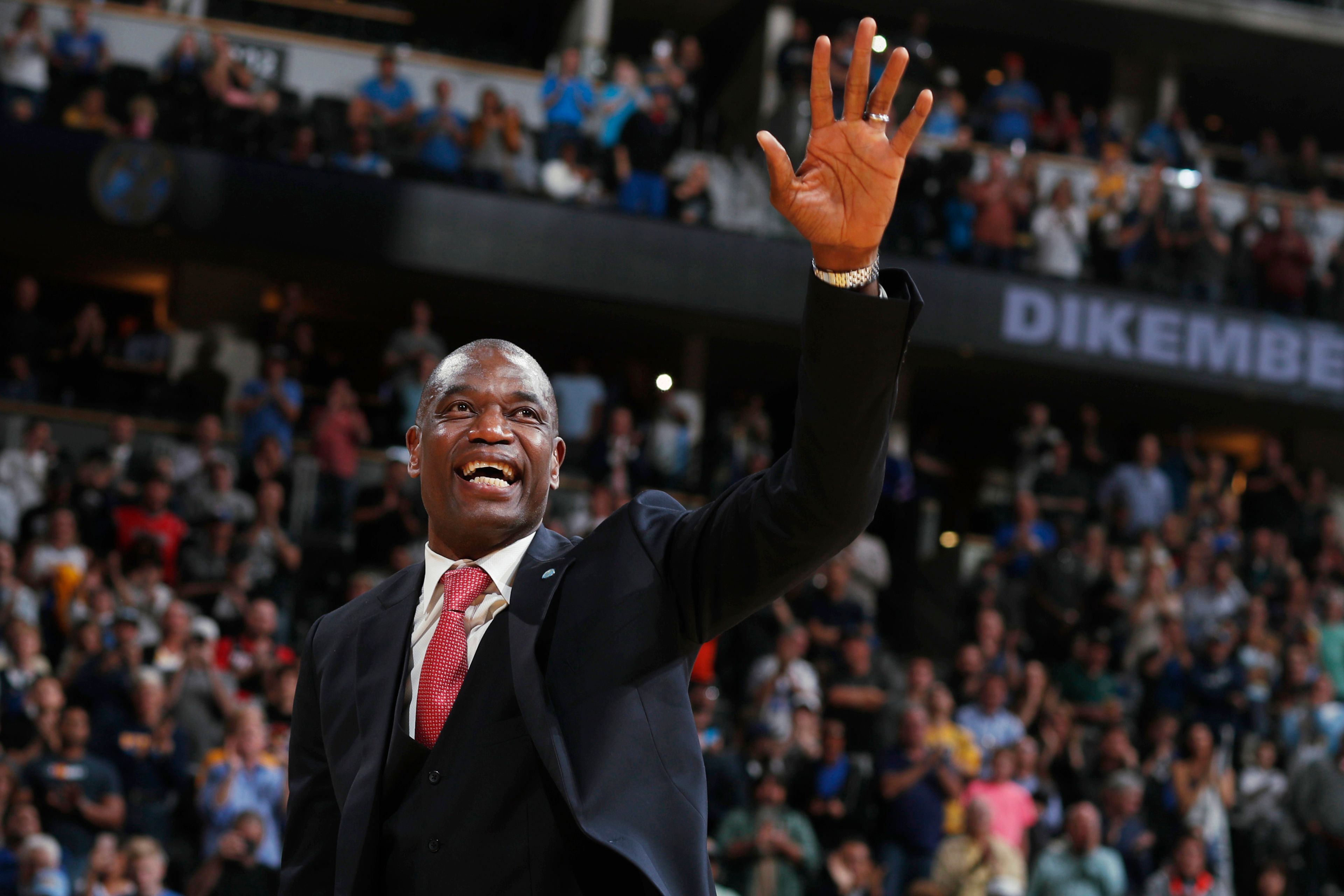 FILE - Retired Denver Nuggets center Dikembe Mutombo waves to the crowd as his jersey number was retired by the team during halftime of the Nuggets' NBA basketball game against the Portland Trail Blazers on Saturday, Oct. 29, 2016, in Denver. (AP Photo/David Zalubowski, File)