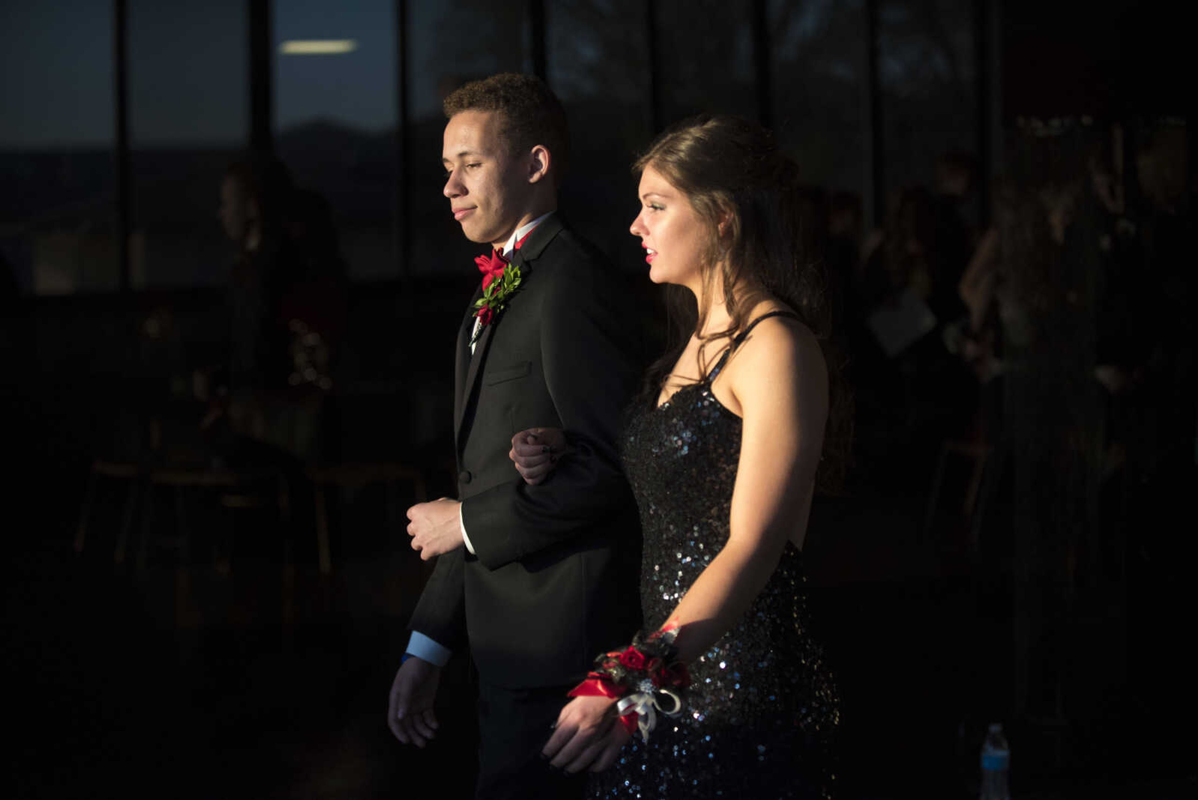 Damion Applewhite and Madeline Hendrix walk for the grand march during the Chaffee prom Saturday, April 1, 2017 at the University Center on the campus of Southeast Missouri State University in Cape Girardeau.