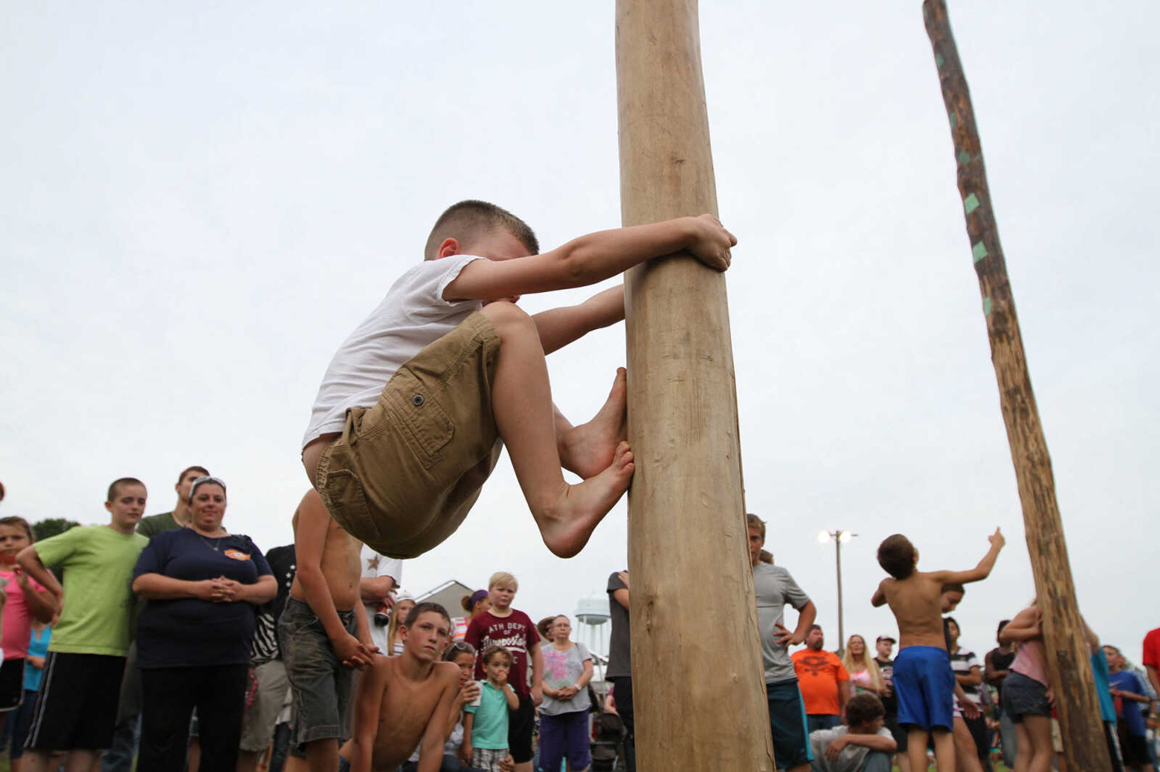 GLENN LANDBERG ~ glandberg@semissourian.com

Braden Riedinger works his way up a greased pole Saturday, Aug. 30, 2014 at Neighbor Days in Benton, Missouri.