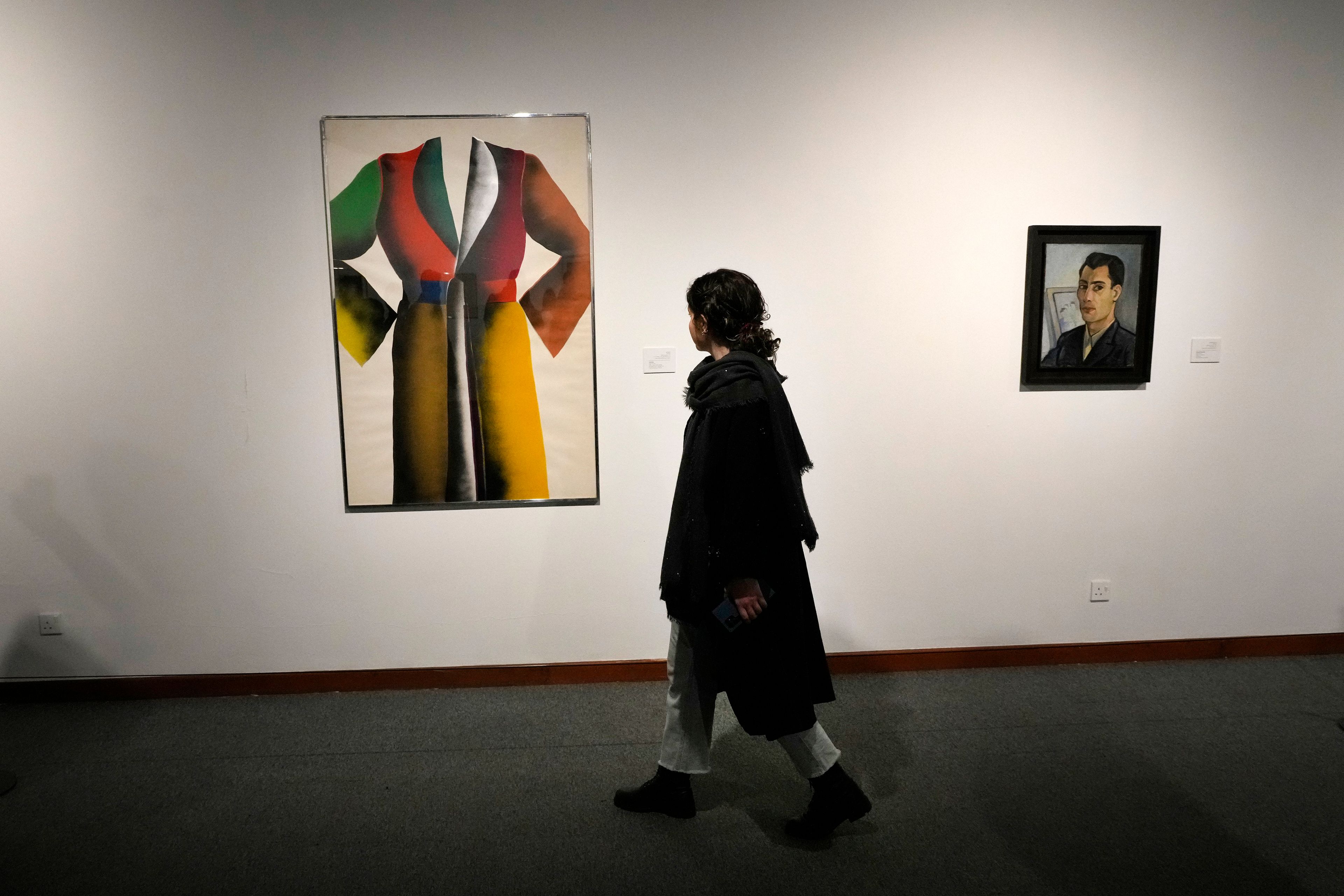 A woman visits an exhibition titled Eye to Eye which showcases over 120 works by modern world artists as well as Iranian painters at Tehran Museum of Contemporary Art, in Tehran, Thursday, Nov. 21, 2024. (AP Photo/Vahid Salemi)