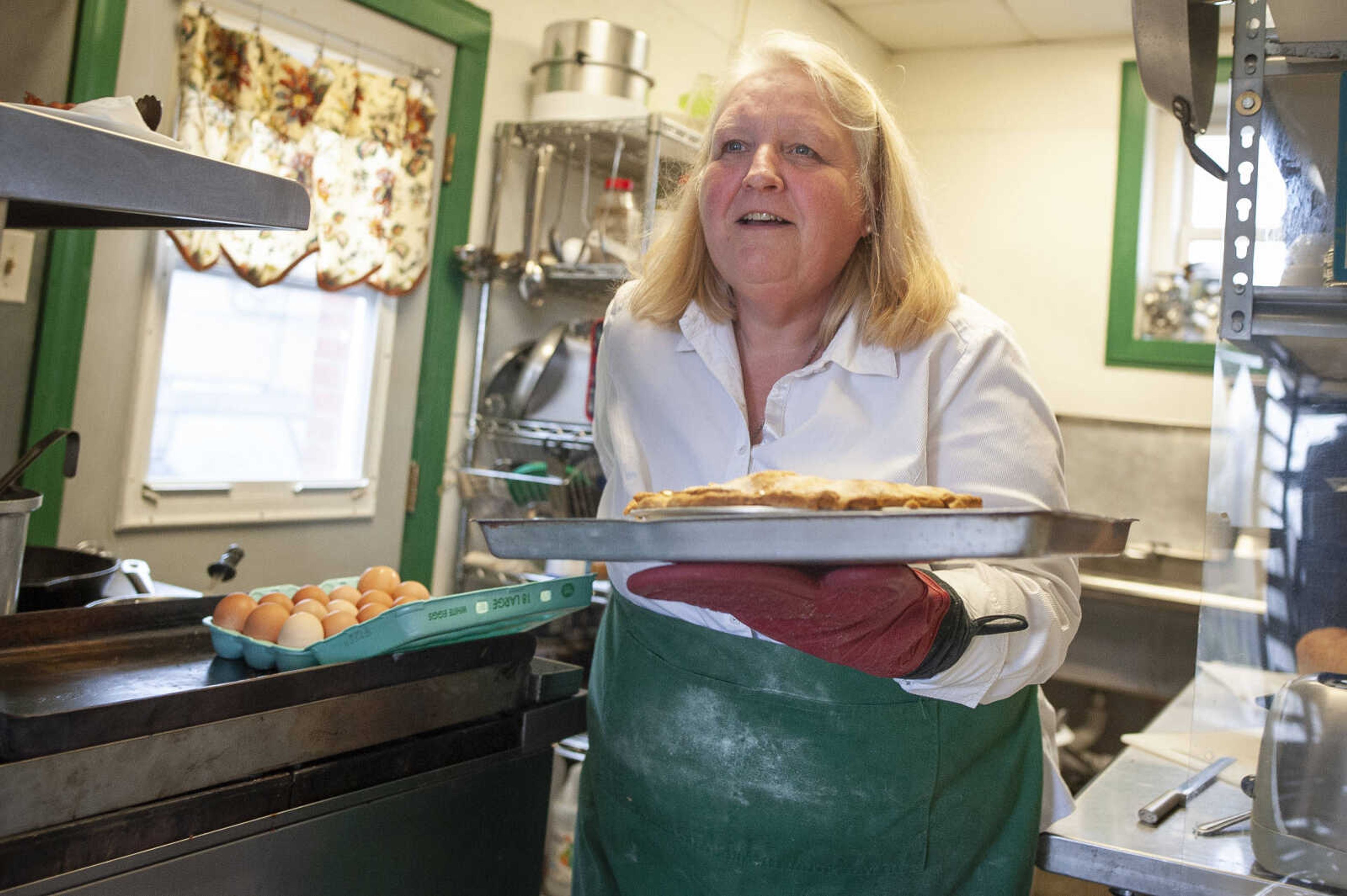 Sharon Penrod takes a pie out of the oven Wednesday, March 11, 2020, at The Pie Safe Bakery &amp; Cafe in Pocahontas.&nbsp;Housed in what used to be a bank and built in 1910, Penrod, who operates the establishment, said The Pie Safe opened June 12, 2012. "It's cause I like to talk," Sharon said when asked if she enjoyed her job. Although she's had some help at times in the past, Sharon is a one-woman show at The Pie Safe. Sharon said her husband, Monte Penrod, restored the whole building.&nbsp;