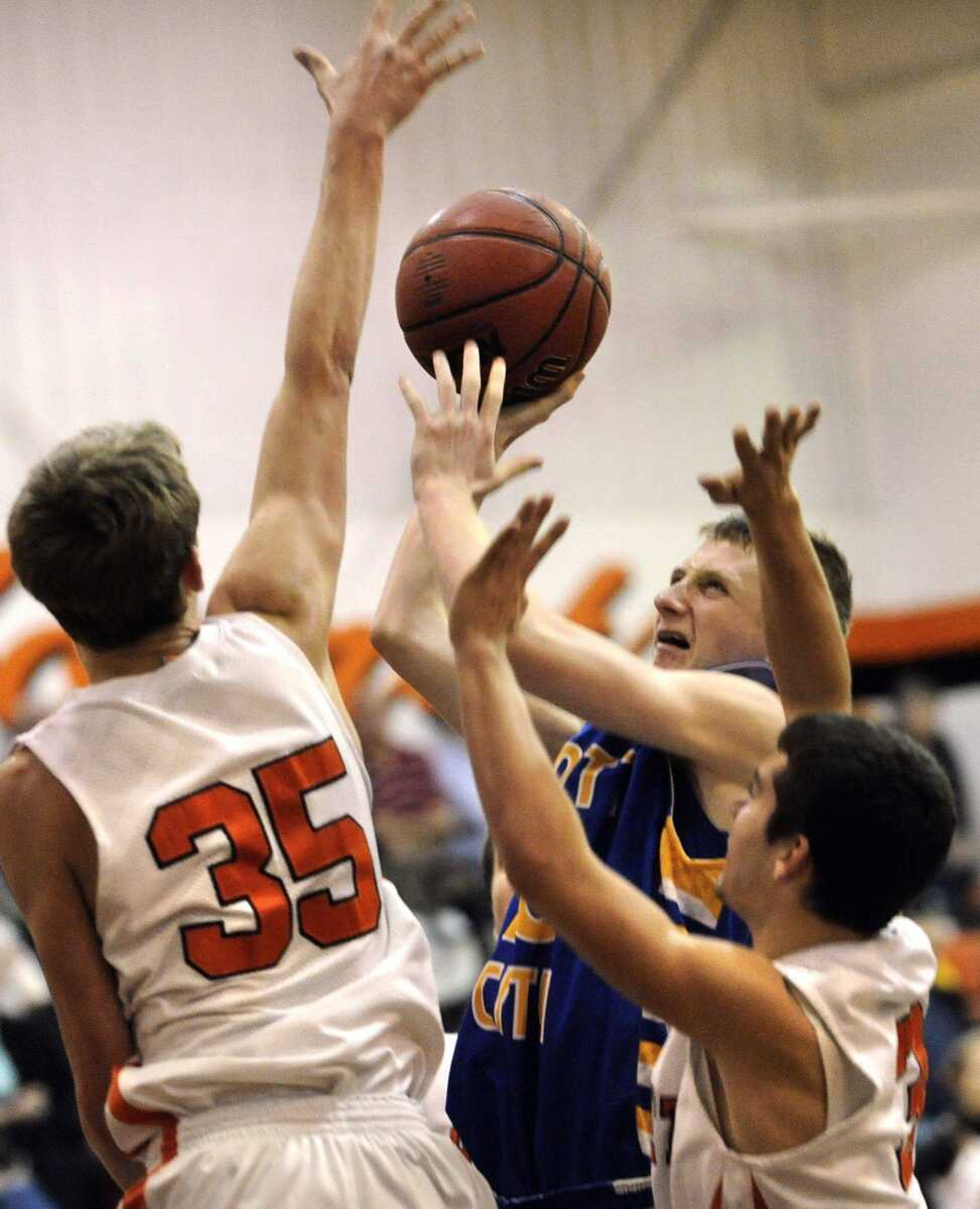 Scott City's Jesse Sanders tries to shoot between Advance's Curtis Gilliland, left, and Tyler Middleton during the fourth quarter Friday.