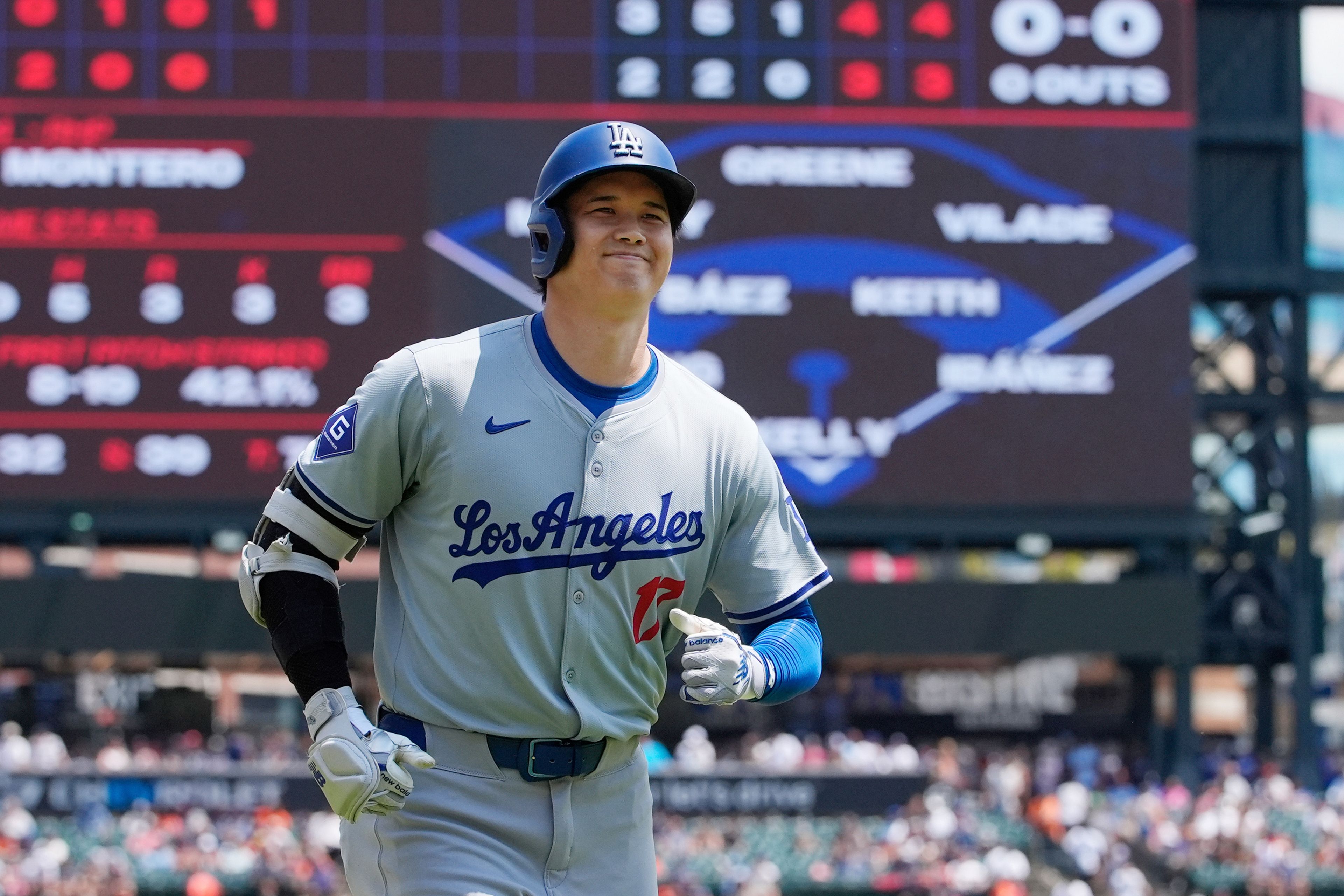 Los Angeles Dodgers designated hitter Shohei Ohtani heads to the dugout after a solo home run during the fifth inning of a baseball game against the Detroit Tigers, Saturday, July 13, 2024, in Detroit. (AP Photo/Carlos Osorio)