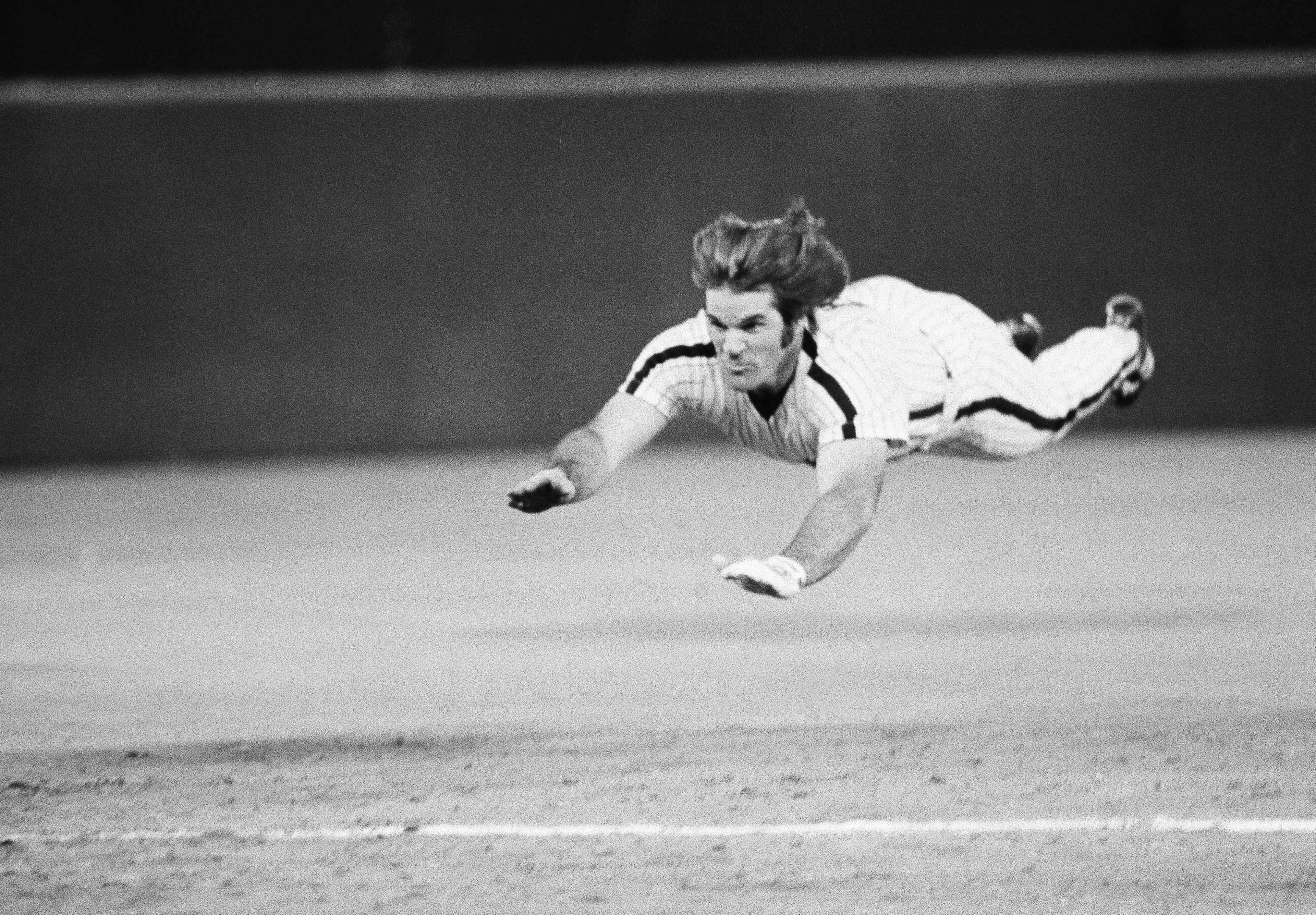 FILE - Philadelphia Phillies' Pete Rose slides to third base during a baseball game against the New York Mets in Philadelphia, June 3, 1981. (AP Photo/Rusty Kennedy, File)