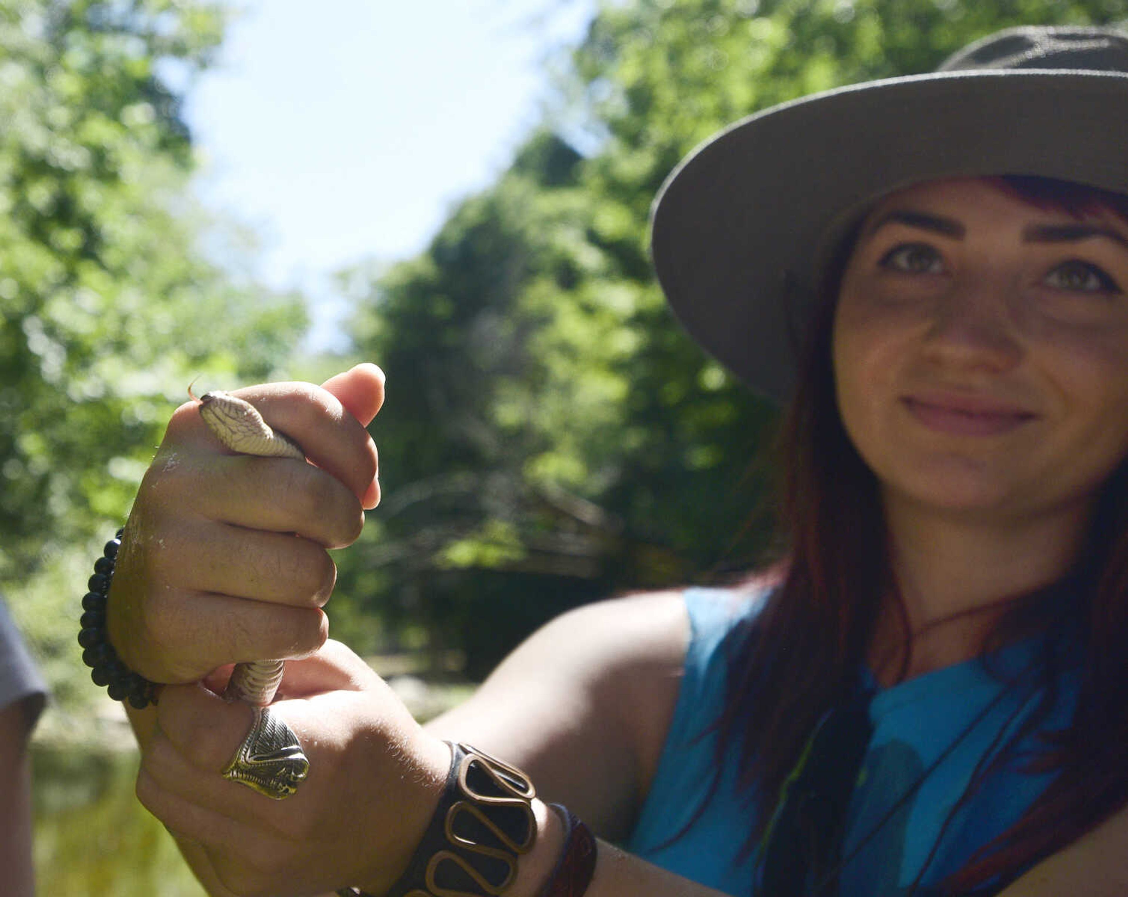 Anna Mae Zembsch handles a small Northern Water Snake she and Jordyn Richmond found in Little Indian Creek near Oriole, Missouri.