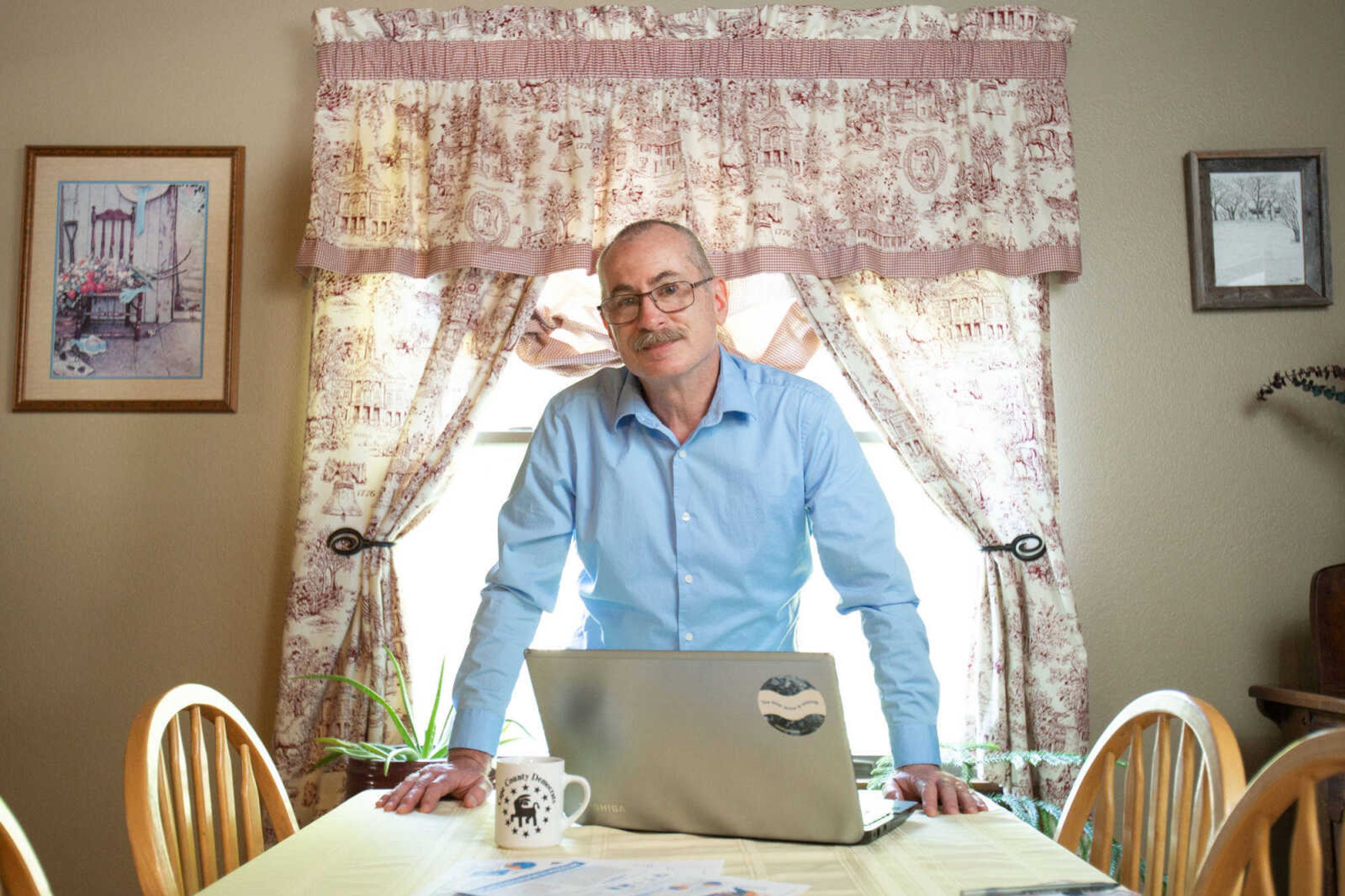 Andy Leighton stands for a photo in his Cape Girardeau home where he lives and works as a medical biller.