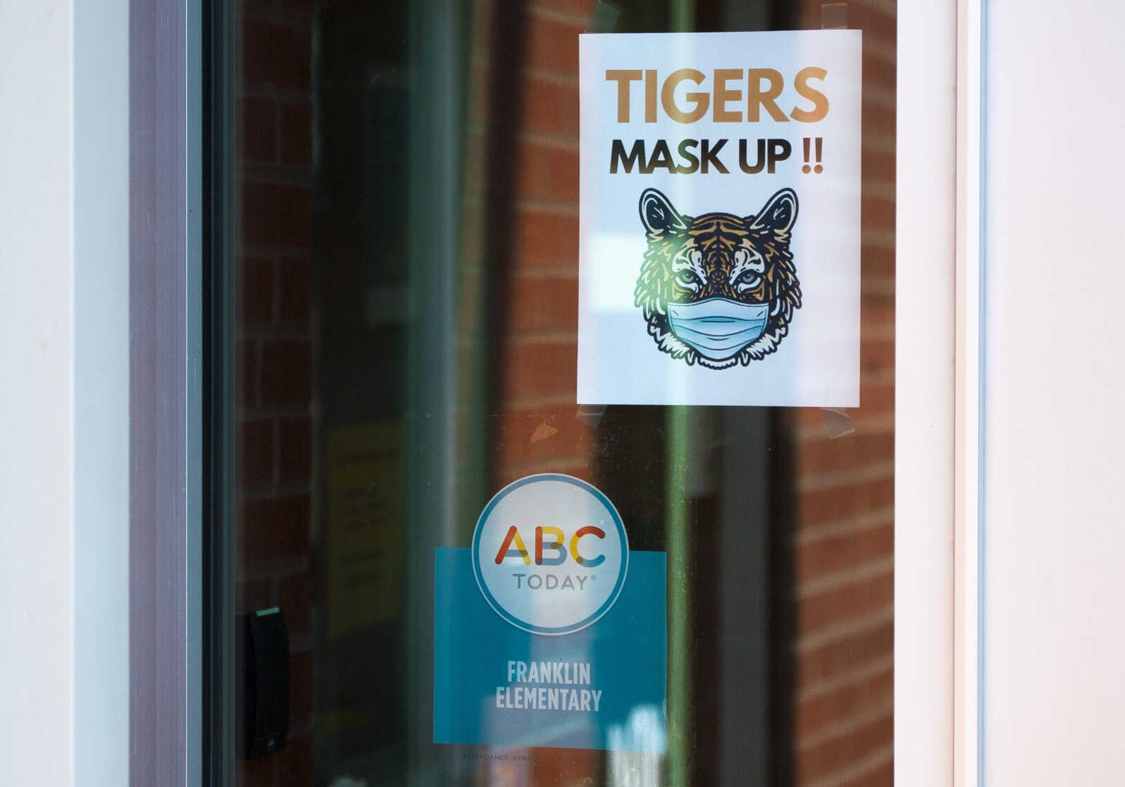 A sign hangs on the door to the Franklin Elementary School main office Monday, Aug. 24, 2020, reminding students and staff to wear face masks.