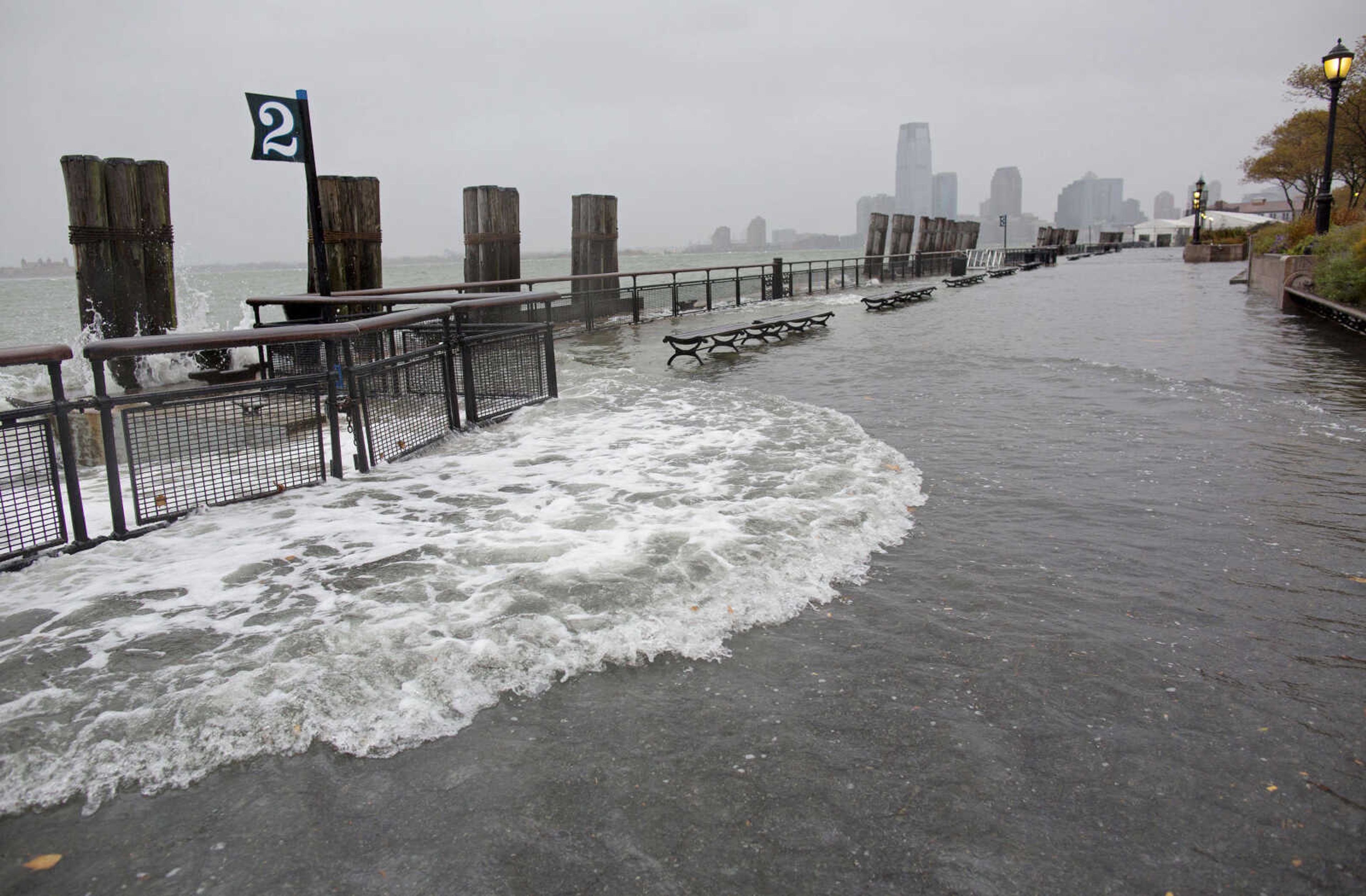 Waves wash over the seawall near high tide at Battery Park in New York, Monday, Oct. 29, 2012, as Hurricane Sandy approaches the East Coast. (AP Photo/Craig Ruttle)