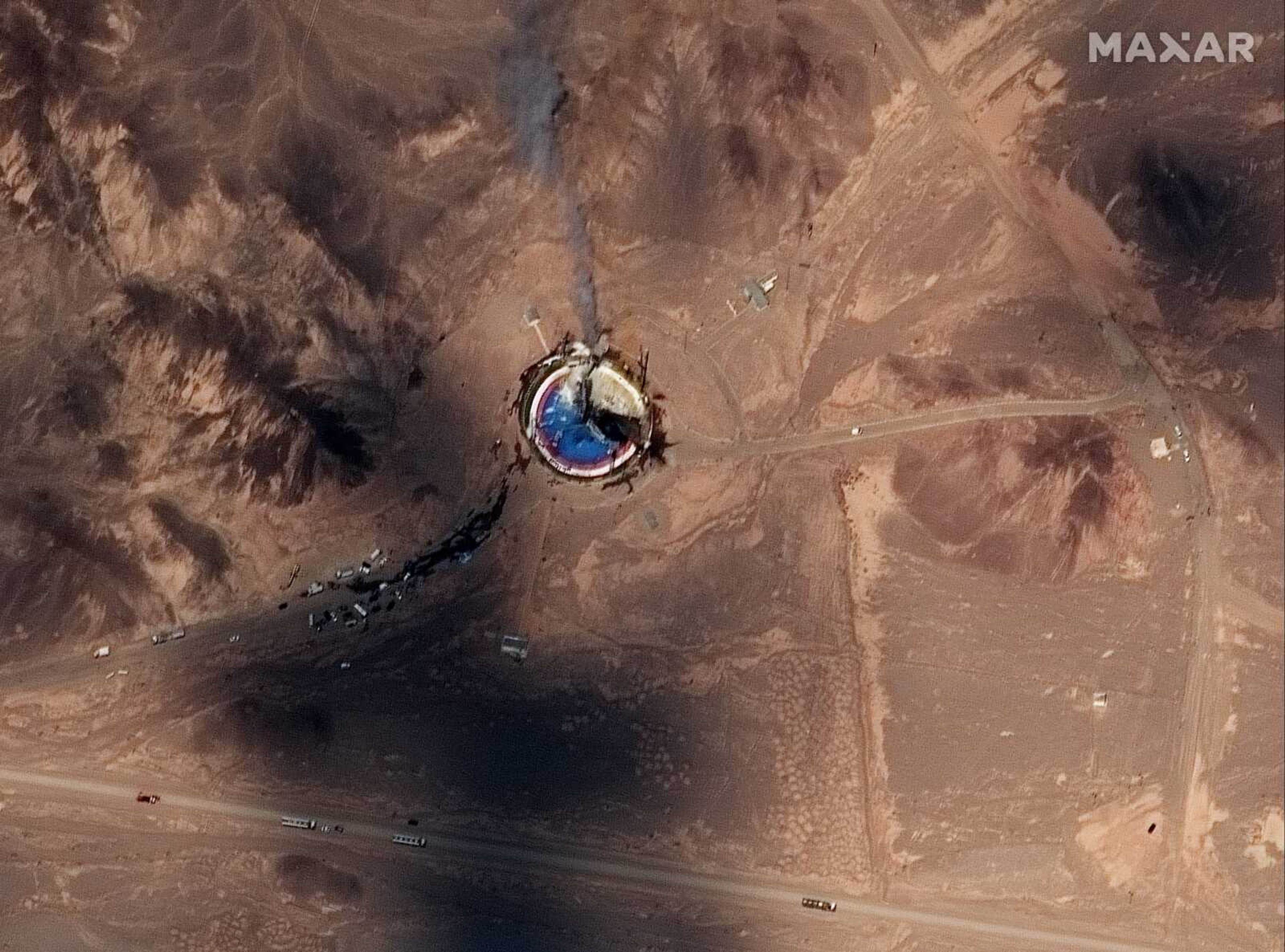 This satellite image from Maxar Technologies shows a fire at a rocket launch pad at the Imam Khomeini Space Center in Iran's Semnan province Thursday.