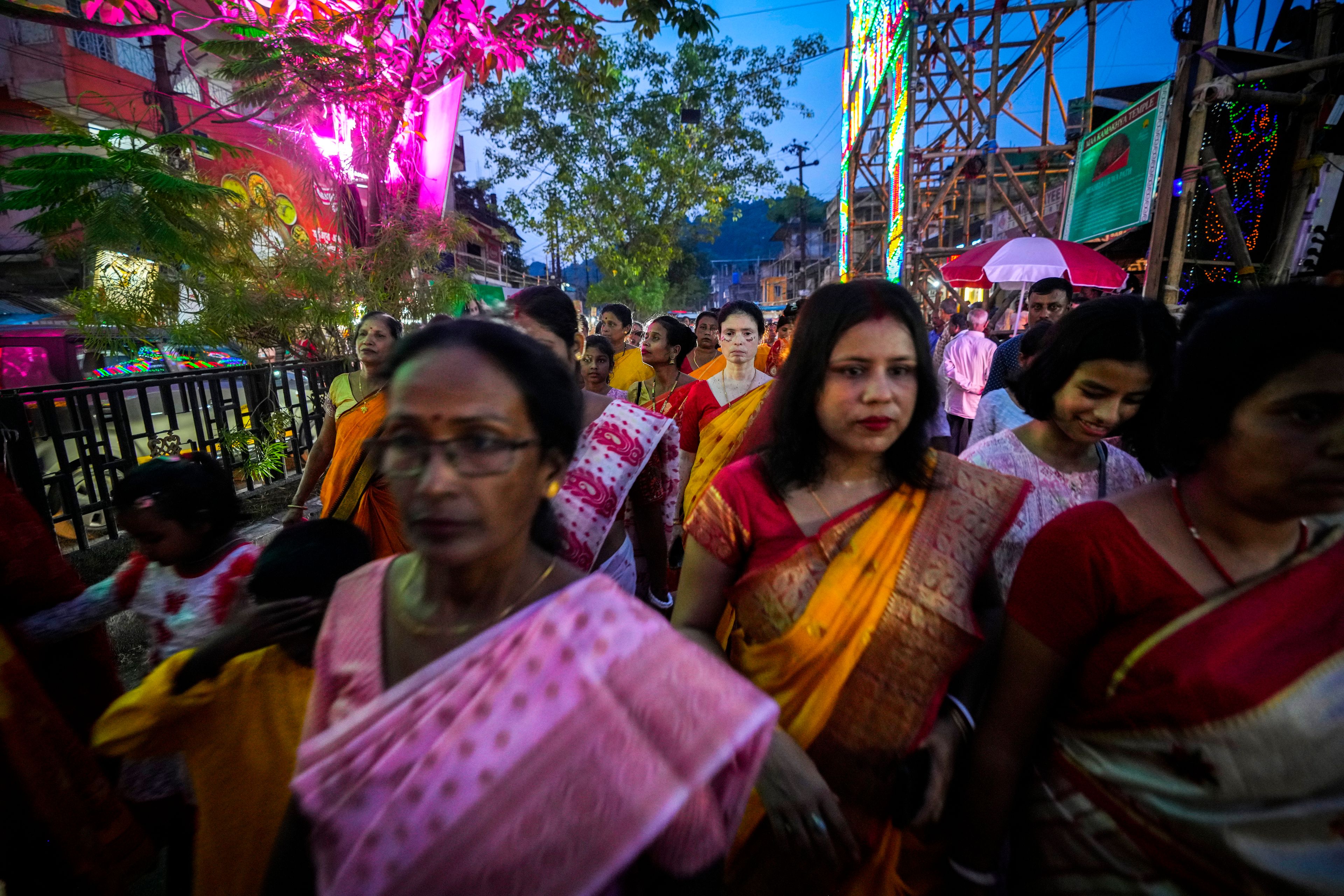 Hindu women devotees participate in a ritual procession during the Durga Puja festival in Guwahati, India, Tuesday, Oct. 8, 2024. (AP Photo/Anupam Nath)