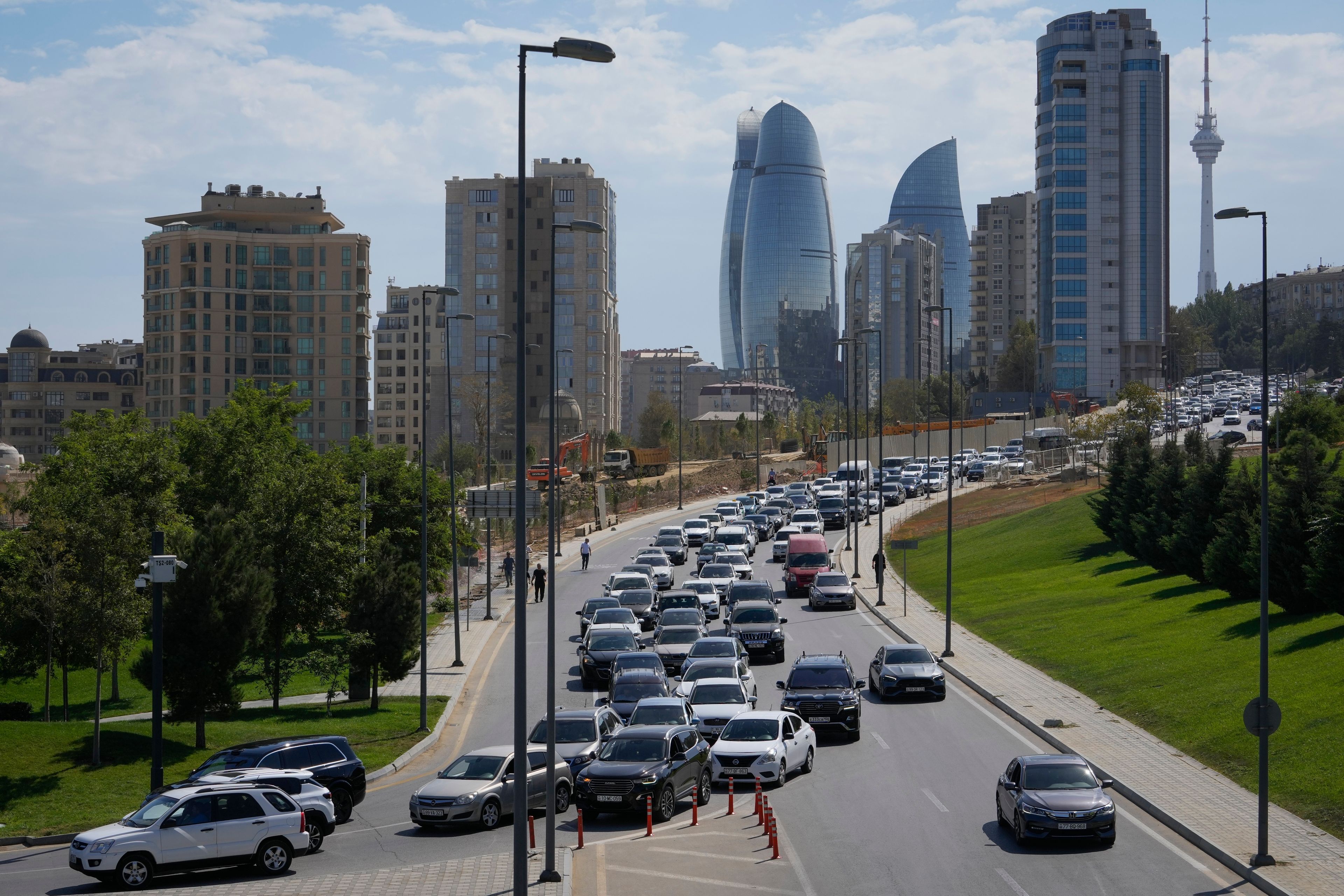 Vehicles travel down a street in Baku, Azerbaijan, Monday, Sept. 16, 2024. (AP Photo/Sergei Grits)