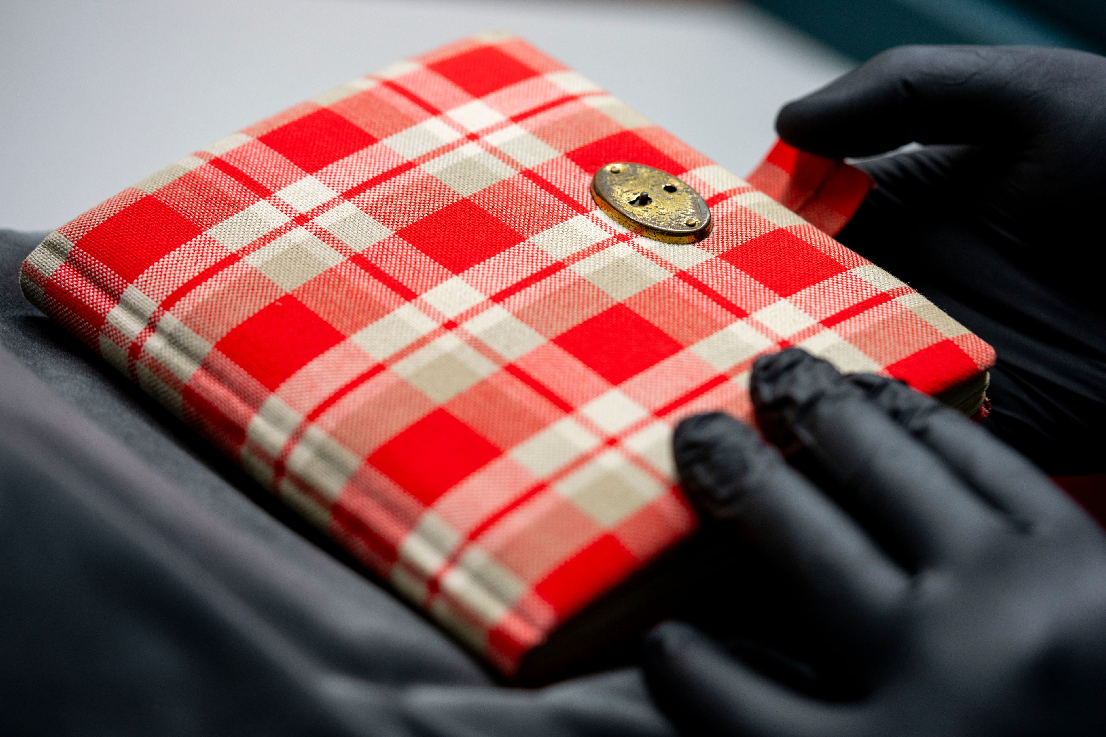 Anne Frank's diary, a red checkered notebook, the cornerstone of the Amsterdam museum's collection, is displayed in Amsterdam, Netherlands, Friday, Oct. 4, 2024. (AP Photo/Peter Dejong)