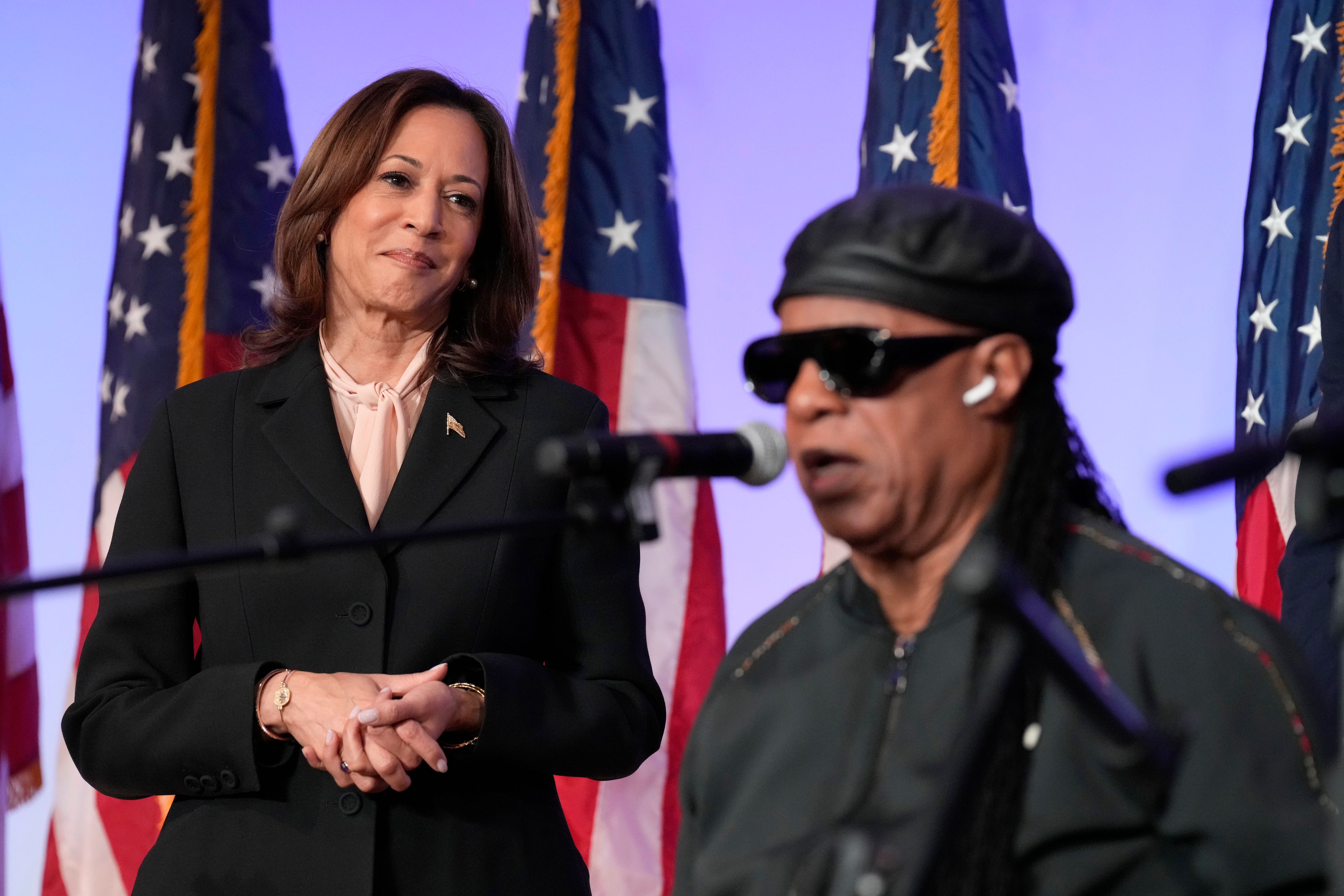 Democratic presidential nominee Vice President Kamala Harris looks on as Stevie Wonder sings "Happy Birthday" to Harris during a church service and early vote event at Divine Faith Ministries International, Sunday, Oct. 20, 2024, in Jonesboro, Ga. (AP Photo/Jacquelyn Martin)