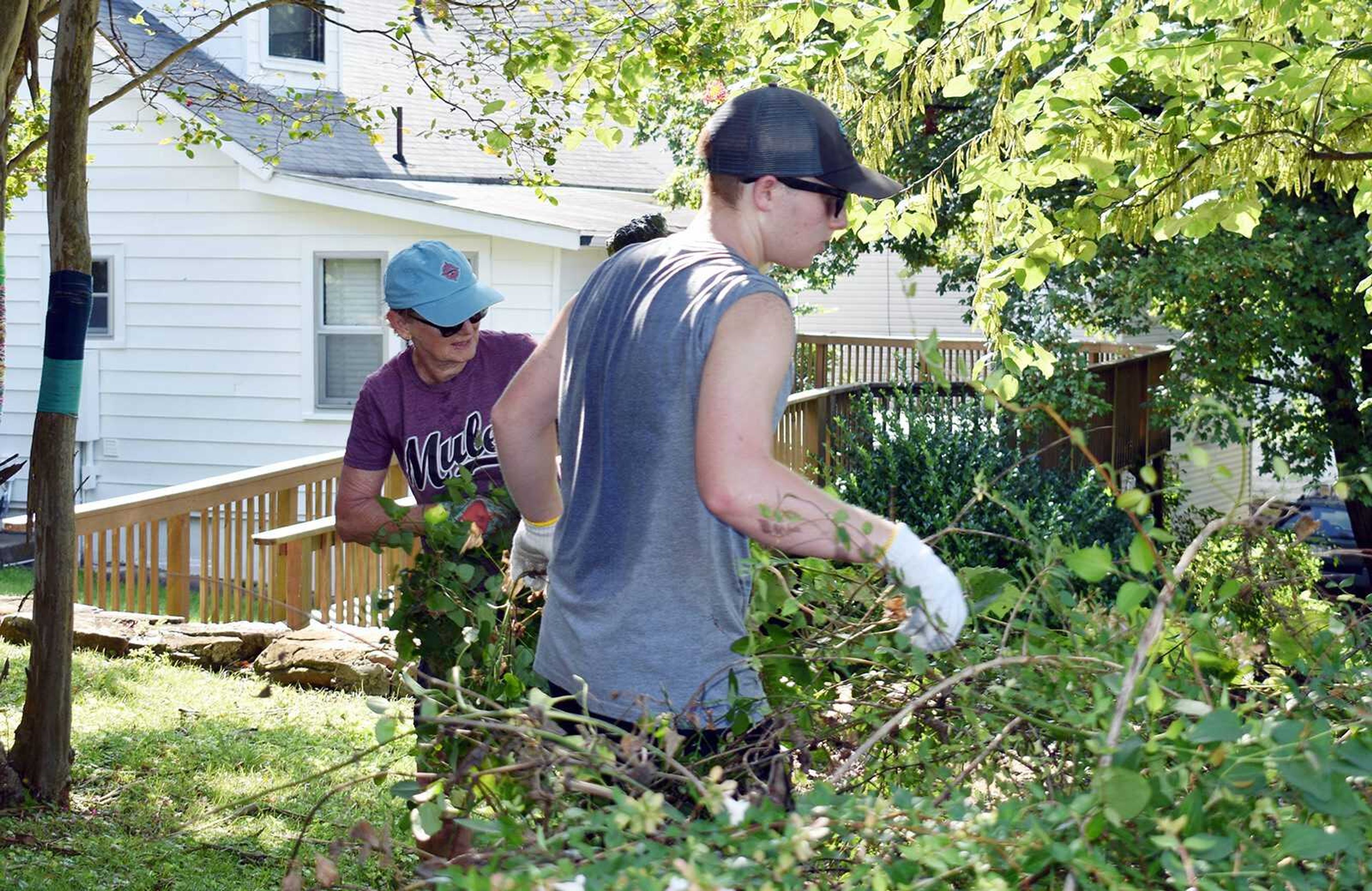 MHAM board member, Carol Davis, at left, and a youth volunteer from North Dakota work hard in the Missouri humidity clearing brush recently on the museum grounds.