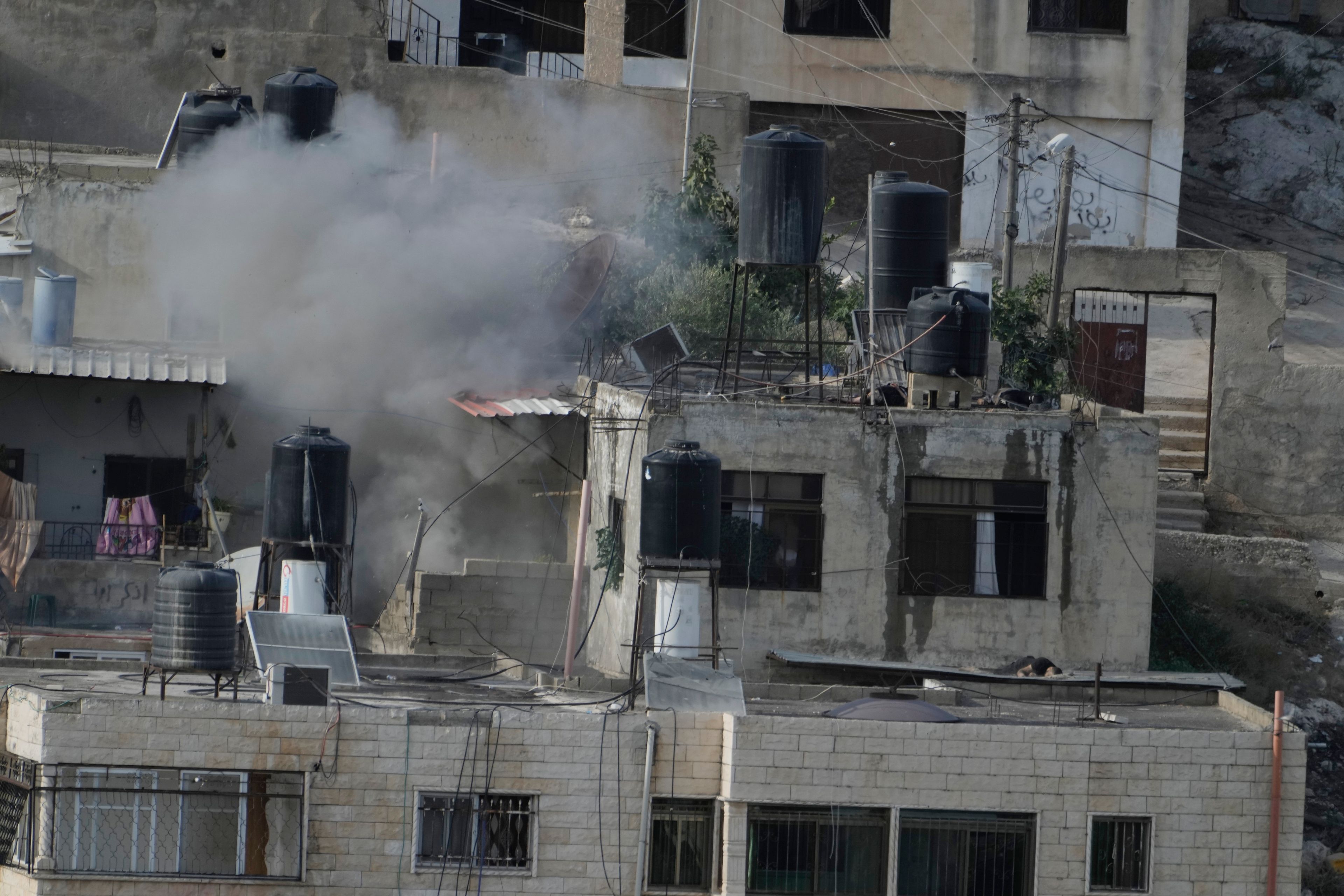 Israeli soldiers pushed three apparently lifeless bodies from roofs during a West Bank raid