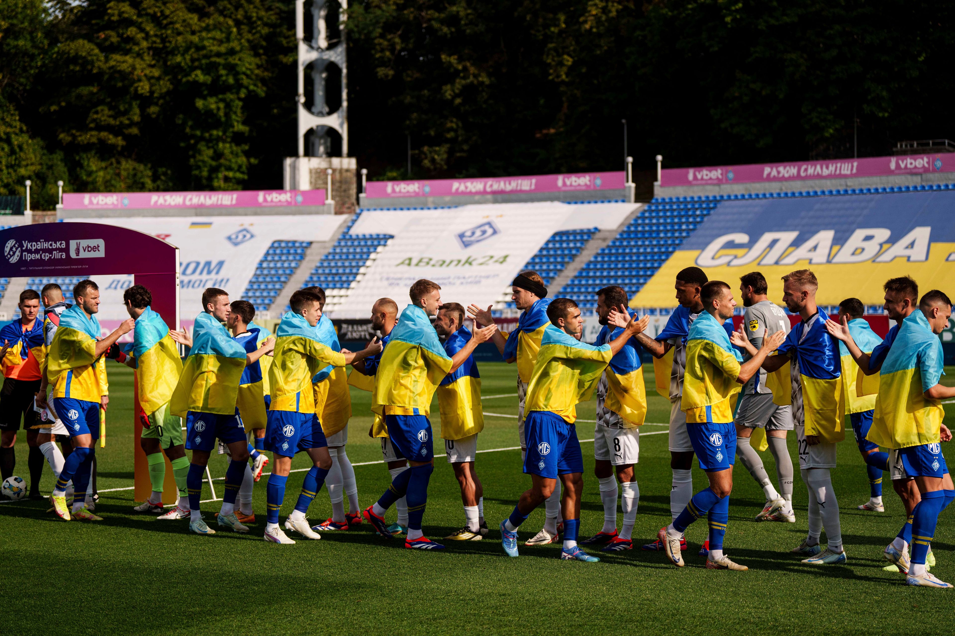 Soccer players of Dynamo Kyiv and Zorya Luhansk great each other before game of Ukrainian Premier League in Kyiv, Ukraine, Saturday Sept. 14, 2024. (AP Photo/Evgeniy Maloletka)