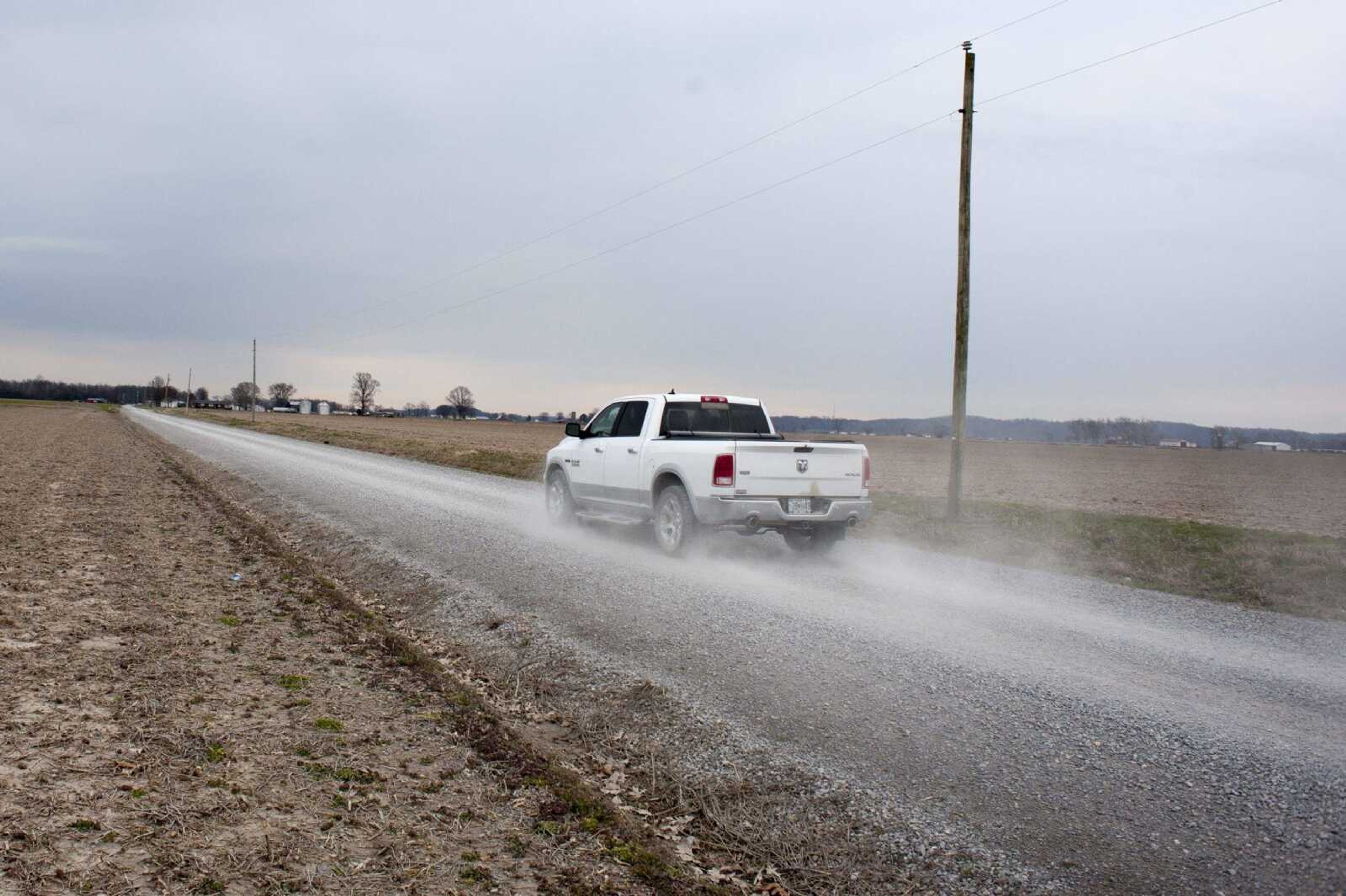 A truck drives along County Road 244 on Wednesday near Dutchtown.  The road is on a waiting list to be paved.