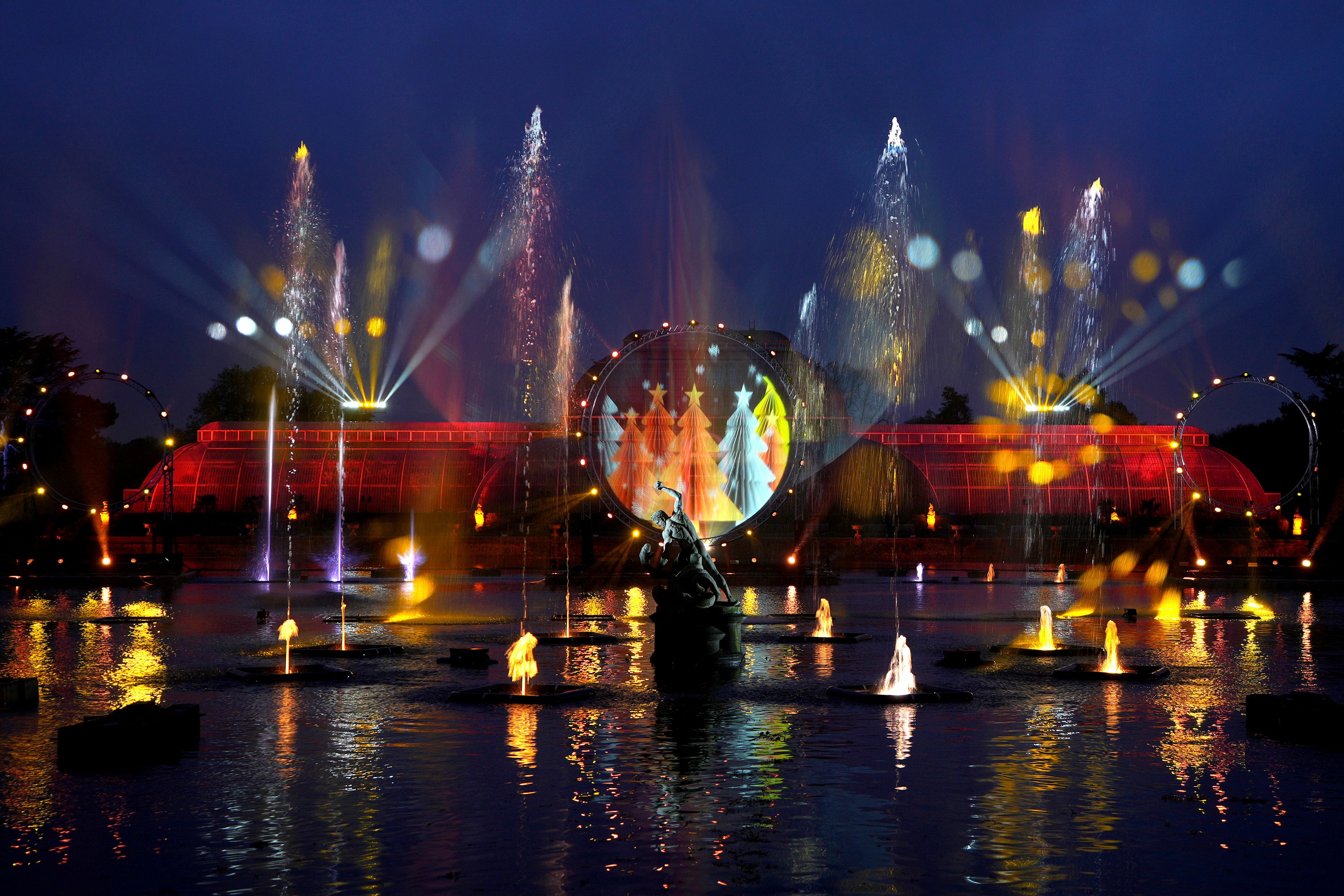 A light display seen across the lake towards the Palm House at the Christmas light trail as it returns for its12th year with new installations set within the UNESCO World Heritage Site landscape of Kew Gardens in London, England, Tuesday, Nov. 12, 2024. (AP Photo/Kirsty Wigglesworth)