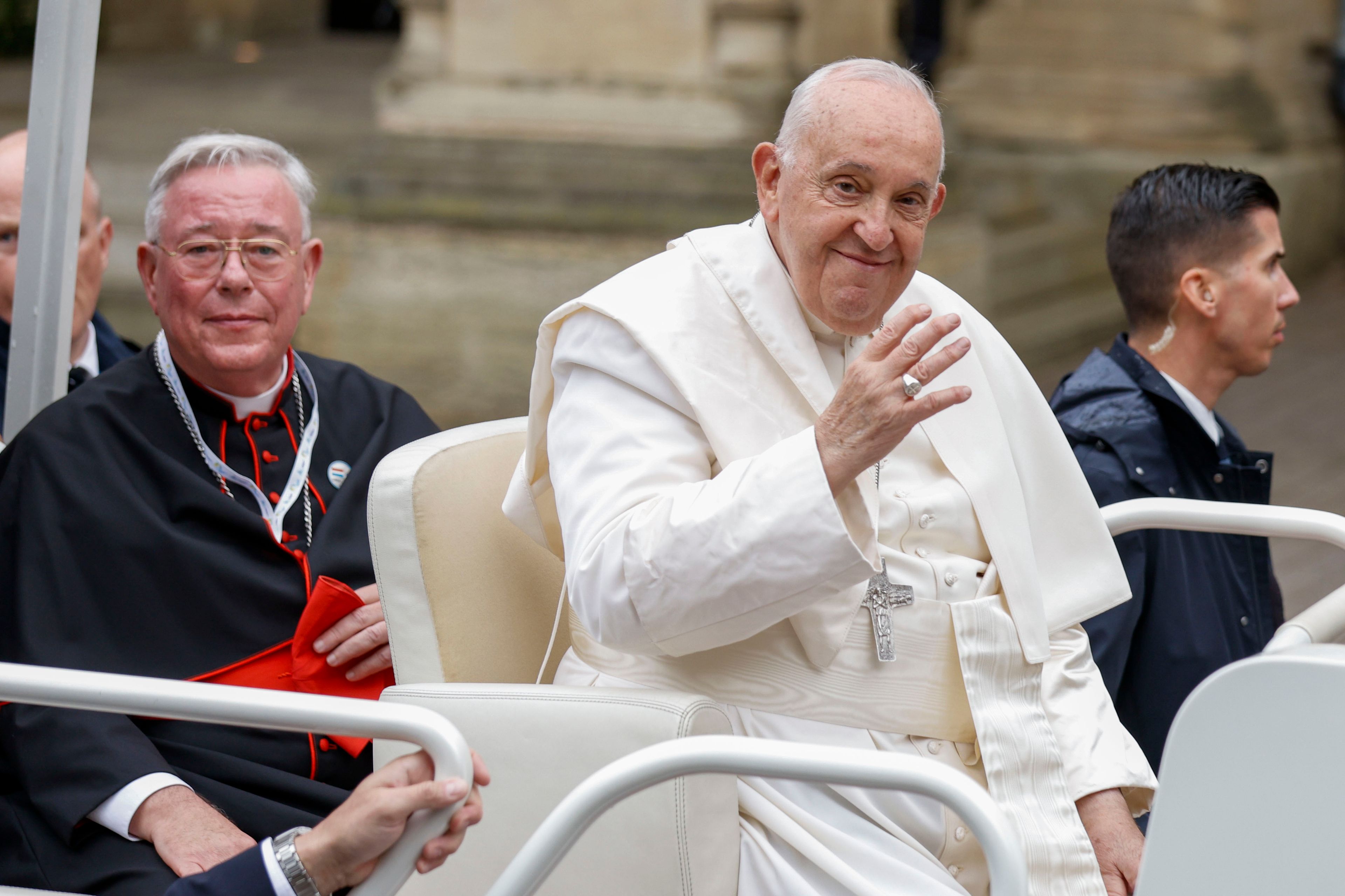 Pope Francis and Archbishop of Luxembourg, Cardinal Jean-Claude Hollerich, left, leave in a popemobile the Cercle-Cite convention center in Luxembourg after a meeting with the national authorities and the civil society on the first day of Francis's four-day visit to Luxembourg and Belgium, Thursday, Sept. 26, 2024. (AP Photo/Omar Havana)