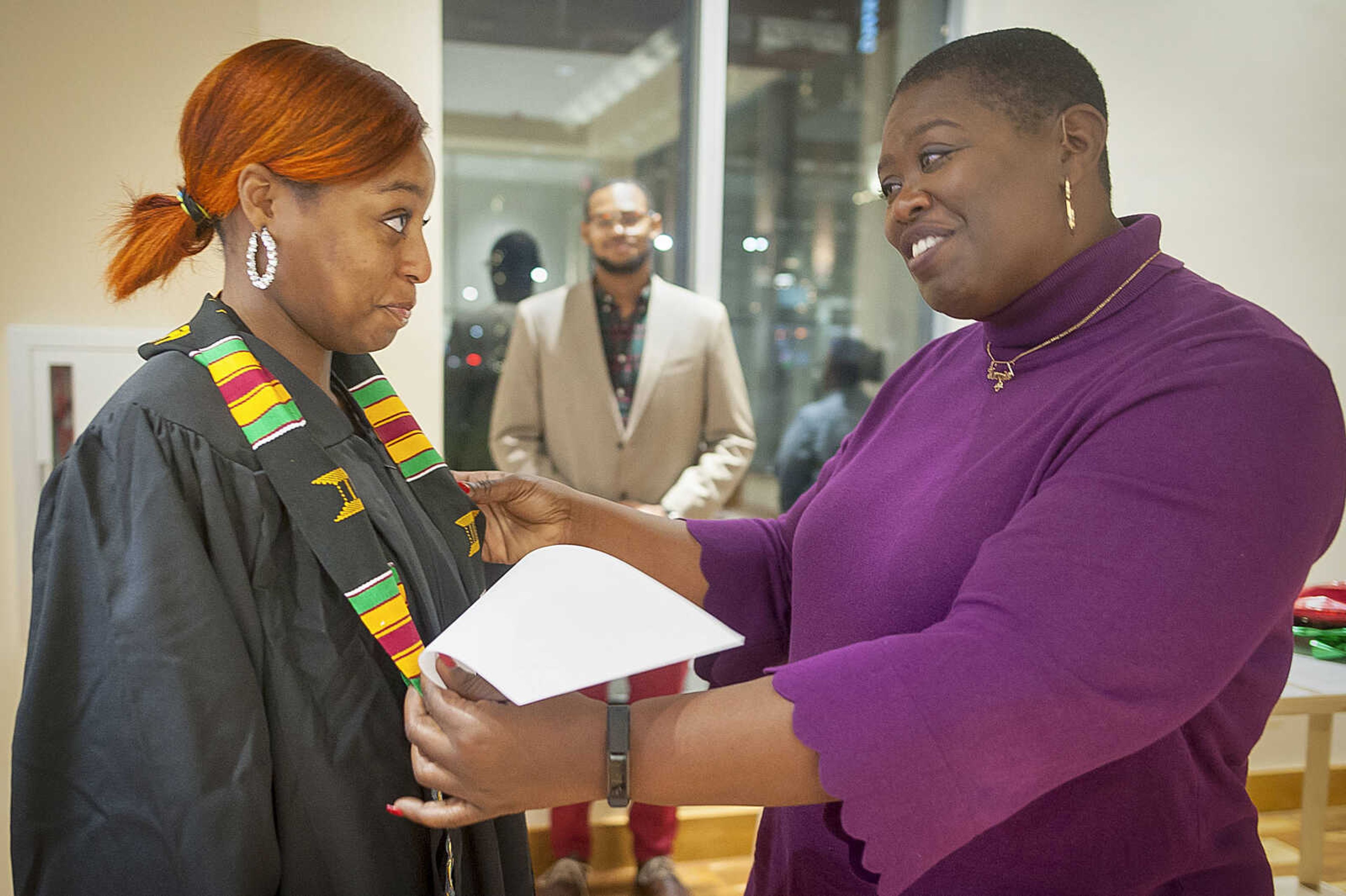 Jasmine Massey, left, is adorned with her Kente stole by advisor Tamara Zellars Buck during the inaugural "Donning of the Kente" ceremony Monday, Dec. 9, 2019, at Rust Center for Media, which recognized graduating members of the National Association of Black Journalists at Southeast Missouri State University in Cape Girardeau.