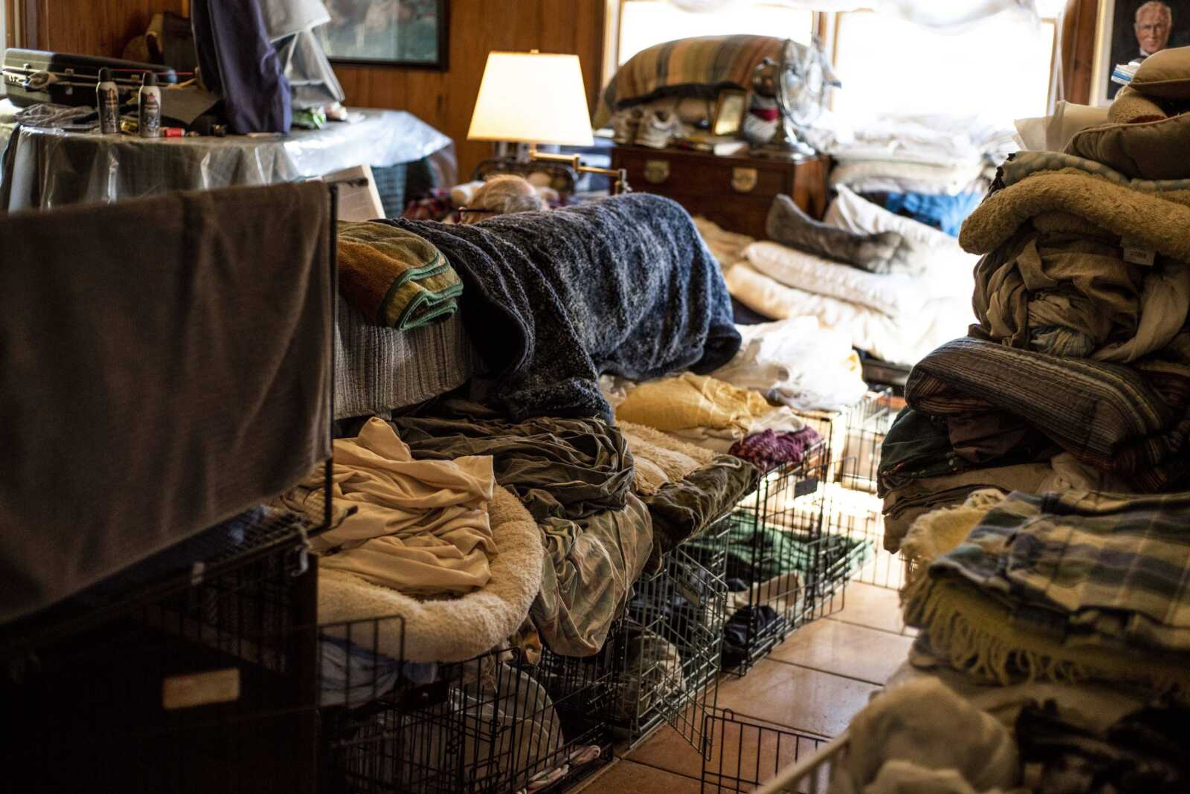 Linens and crates fill the living room space of Marilyn and Michael Neville of the Bollinger County Stray Project Wednesday.