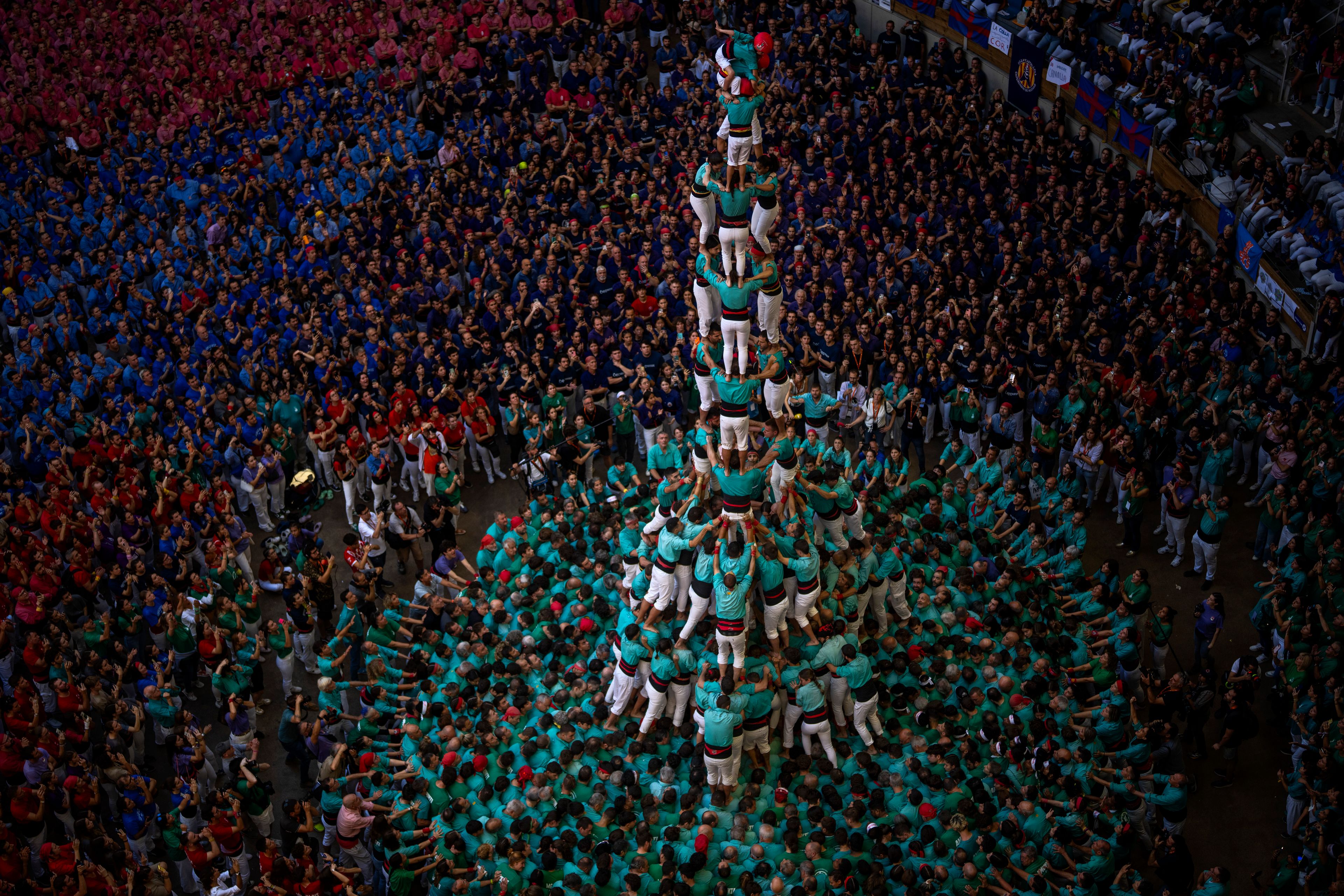 Member of "Castellers de Vilafranca" form a "Castell" or human tower, during the 29th Human Tower Competition in Tarragona, Spain, Sunday, Oct. 6, 2024. (AP Photo/Emilio Morenatti)