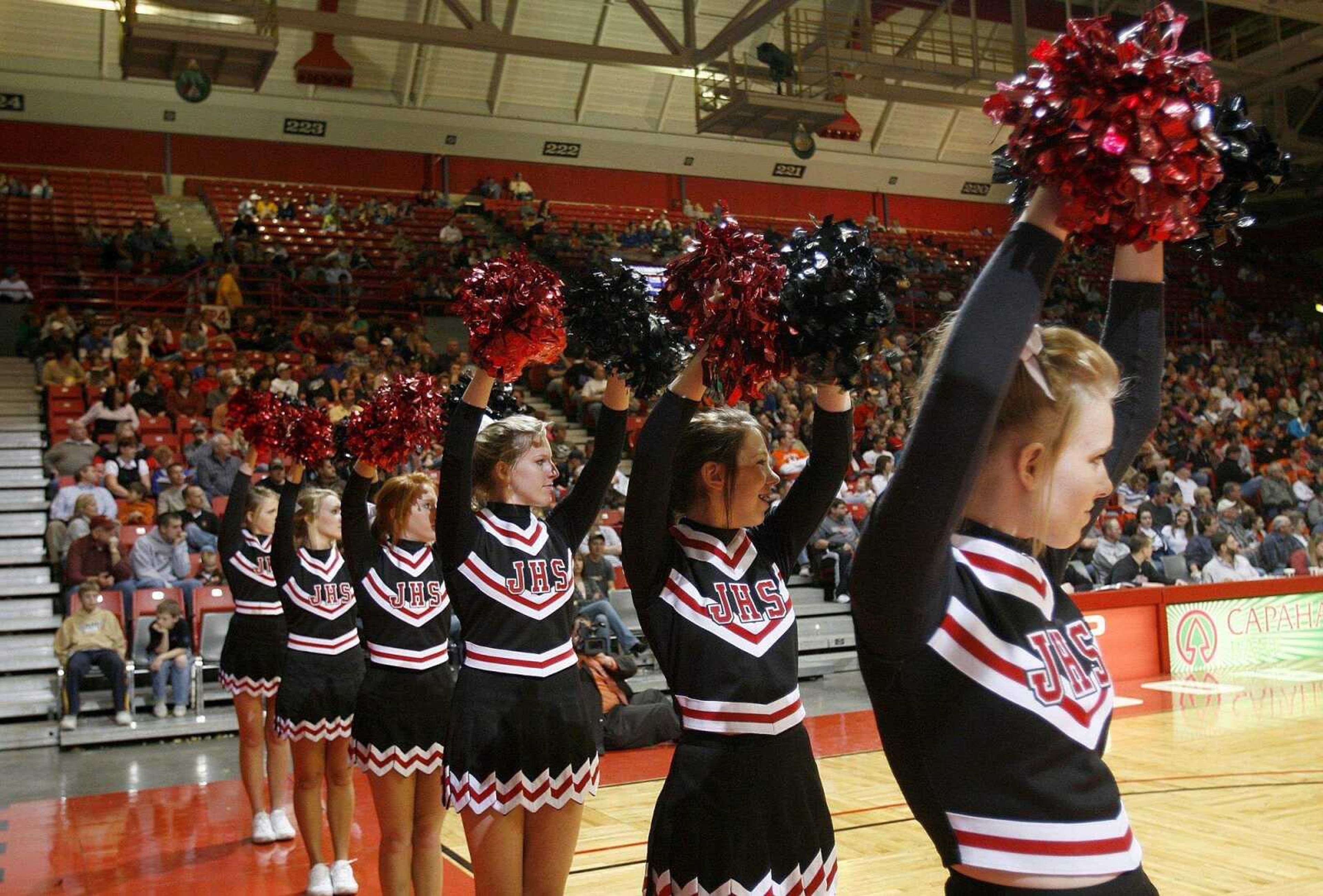 ELIZABETH DODD ~ edodd@semissourian.com
Jackson cheerleaders raise their arms during a free throw in the Christmas Tournament game against Charleston.