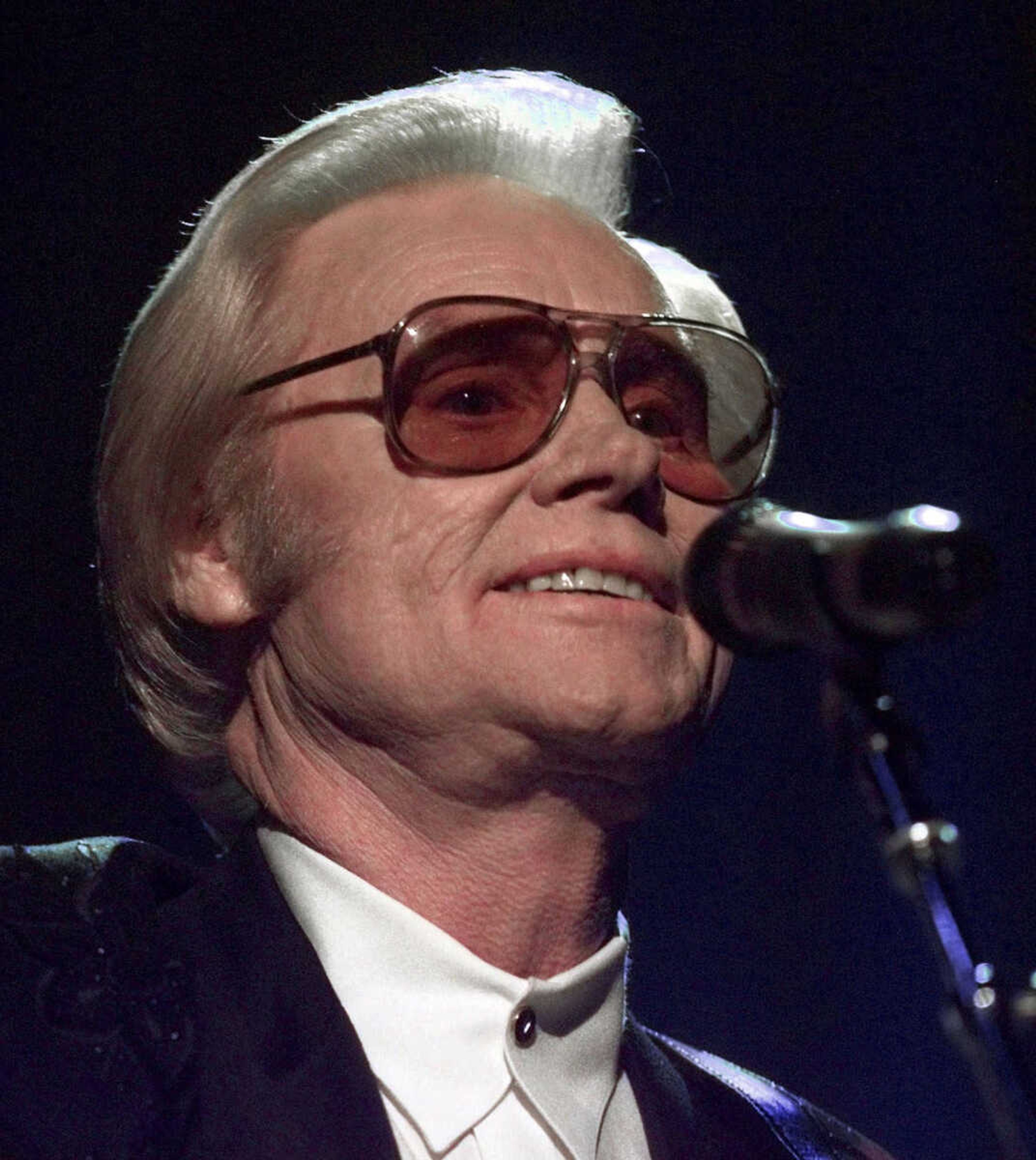 FILE - In this June 1, 1999 file photo, Country music legend George Jones is shown during a performance in Nashville.  Jones, the peerless, hard-living country singer who recorded dozens of hits about good times and regrets and peaked with the heartbreaking classic "He Stopped Loving Her Today," has died. He was 81. Jones died Friday, April 26, 2013 at Vanderbilt University Medical Center in Nashville after being hospitalized with fever and irregular blood pressure, according to his publicist Kirt Webster. (AP Photo/John Russell, file)