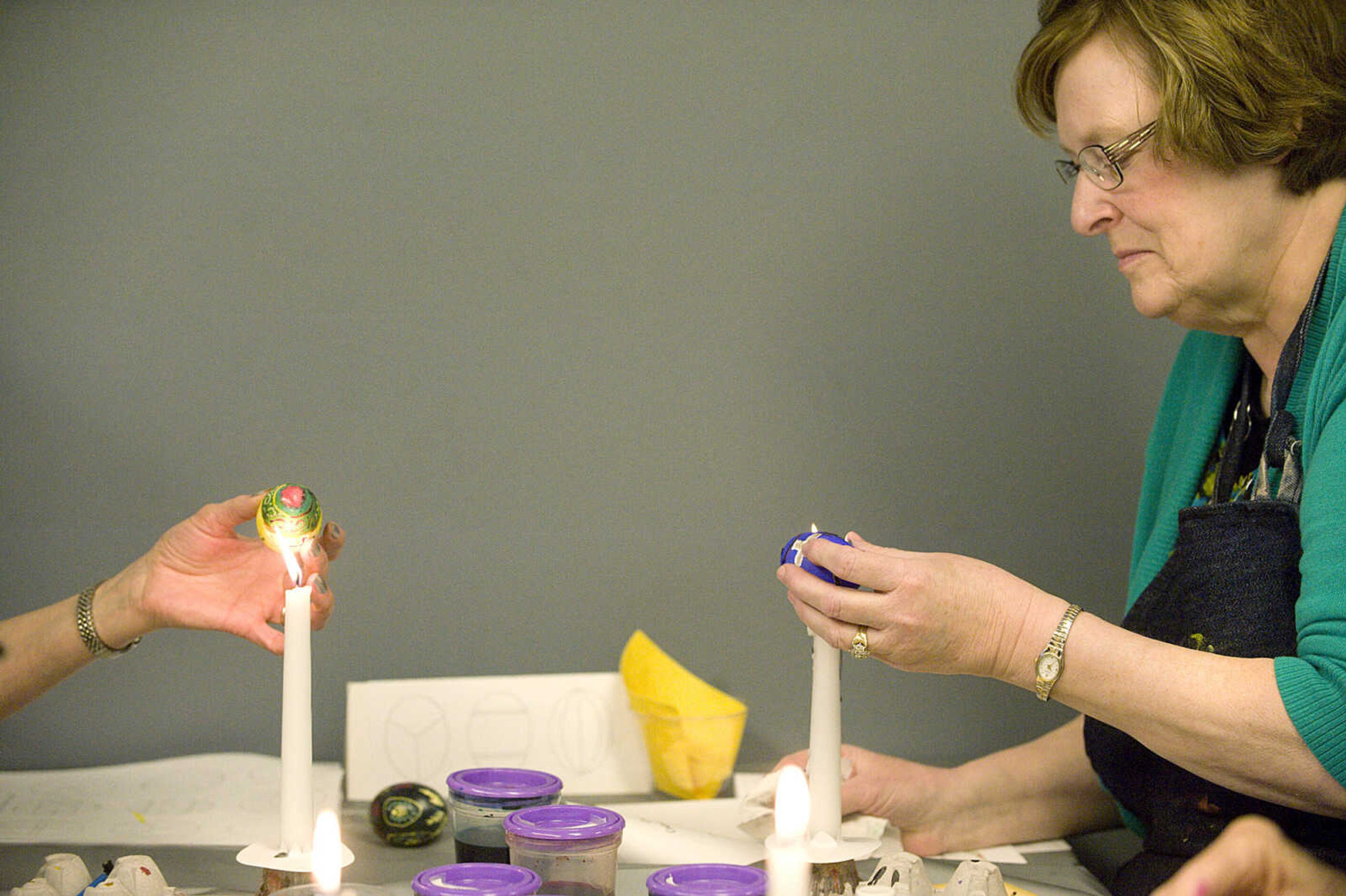 LAURA SIMON ~ lsimon@semissourian.com
Gail Crader melts the beeswax off of her dyed egg Tuesday, March 19, 2013 during the Wonderful World of Pysanky workshop at Southeast Missouri State University's River Campus.