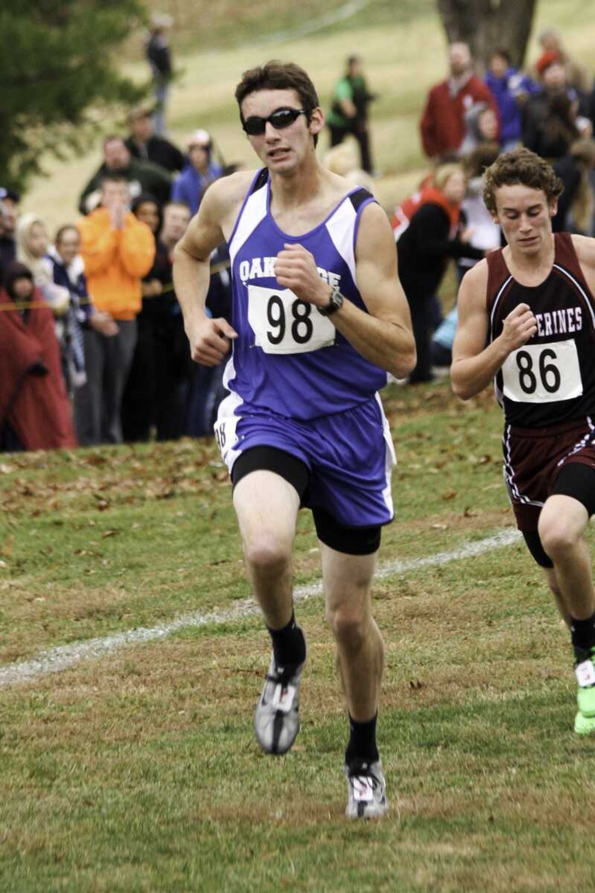 BELOW: Chaffee sophomore Molli McGowan runs to a 52nd-place finish in the Class 1 girls race. (ABOVE: Oak Ridge junior Corvin Schoen powers up the final stretch of the Class 1 boys race.)