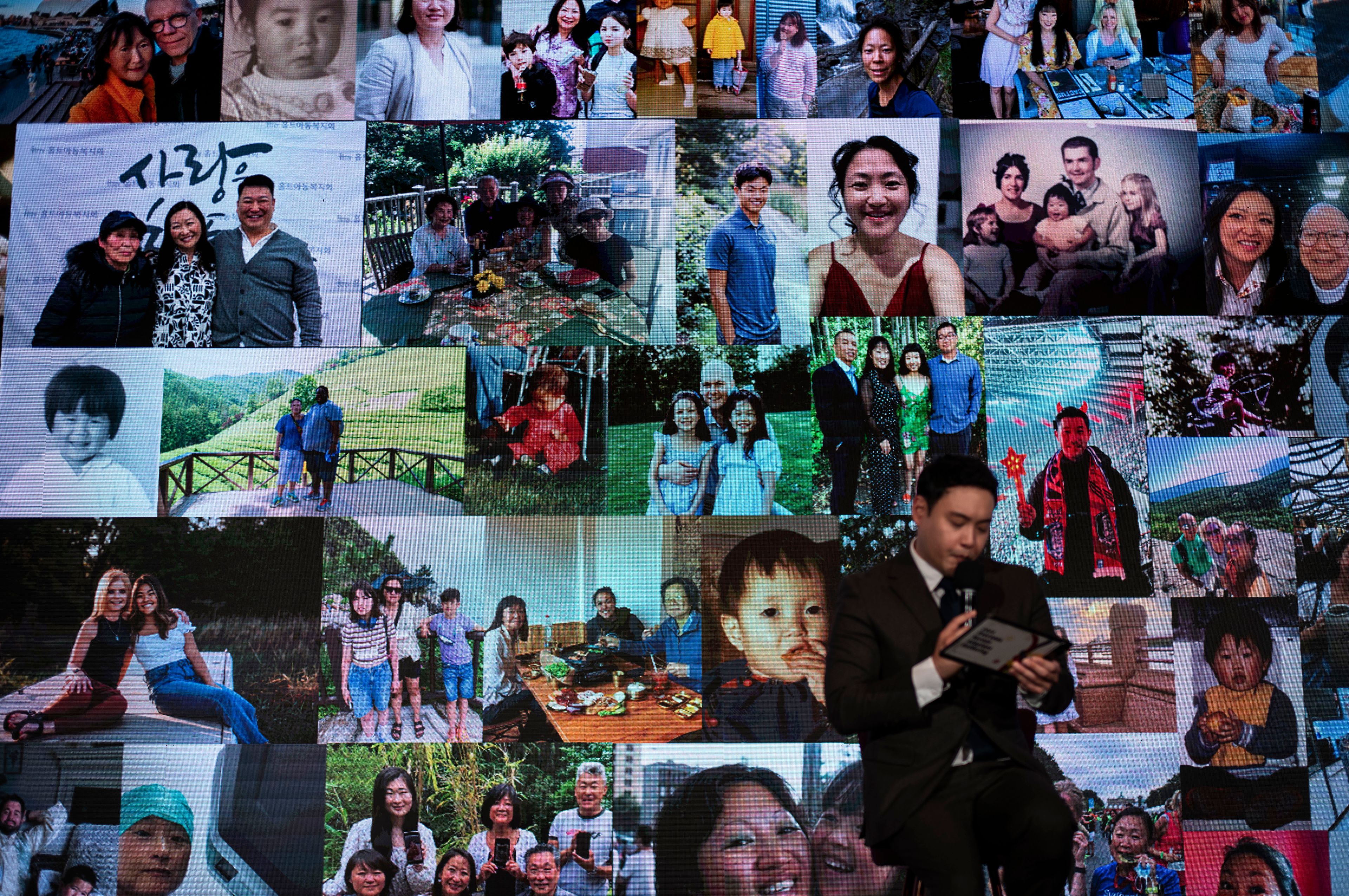 Photos of adoptees participating at the Overseas Korean Adoptees Gathering are displayed on a large screen during the conference in Seoul Tuesday, May 21, 2024. (AP Photo/Jae C. Hong)