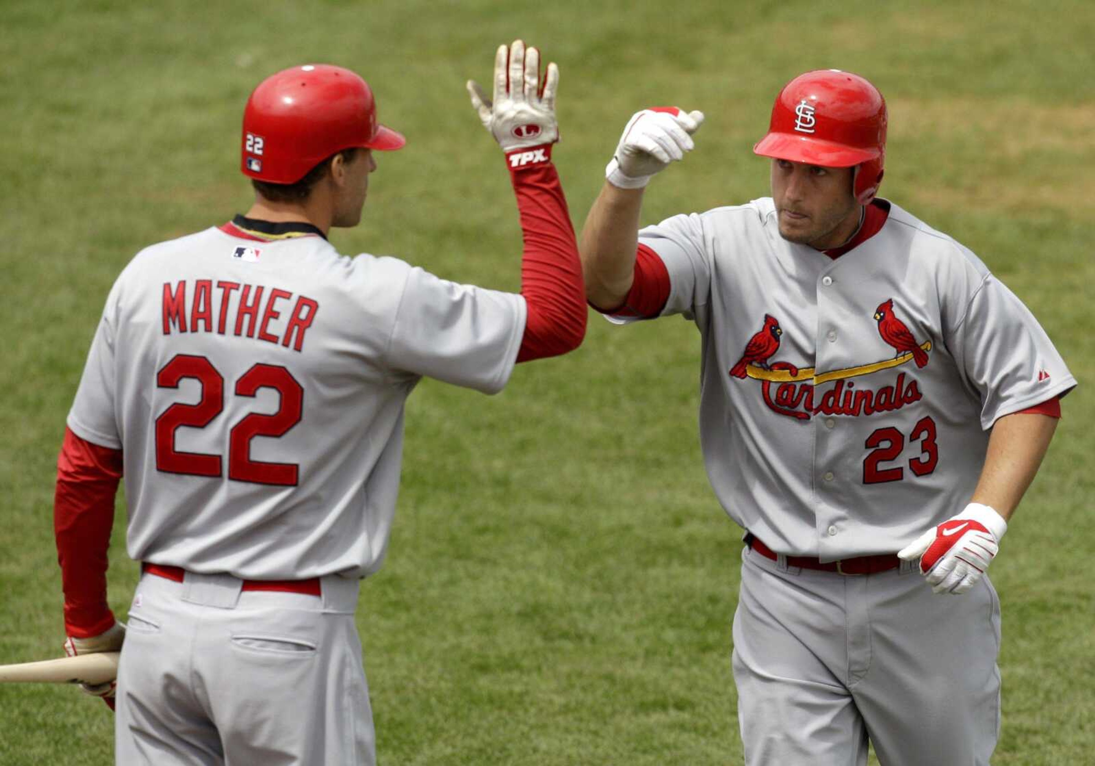 The Cardinals' David Freese celebrates with Joe Mather after Freese hit a three-run home run during the first inning of a spring training game Monday against the Houston Astros in Kissimmee, Fla. St. Louis won the split-squad game 6-4. (CHARLIE RIEDEL ~ Associated Press)