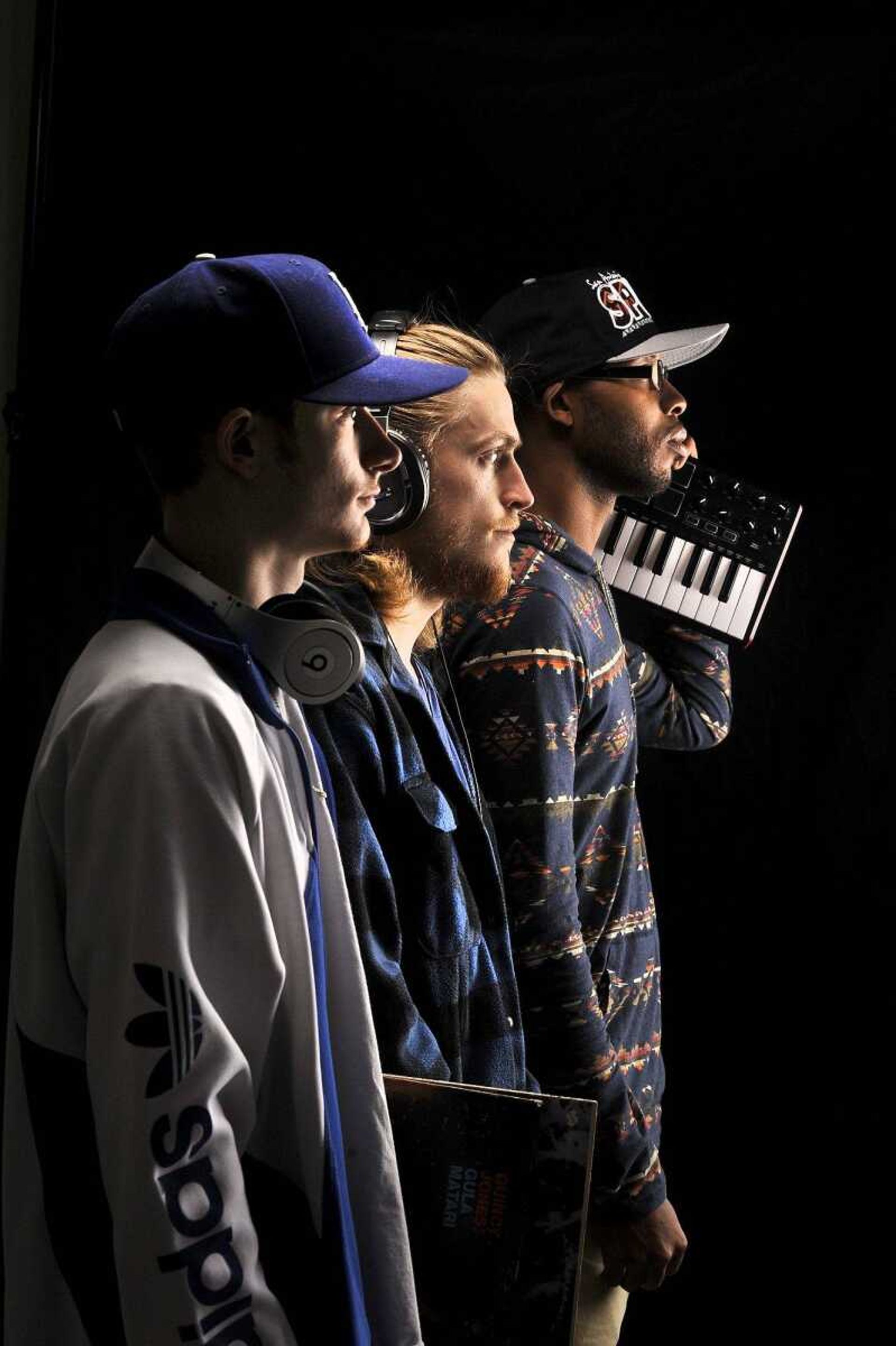 Nik " Niko Scarpy" Scarpaci, left, Angelo "Gelo" Wilson, center, and Amir "Amirical" Waters of hip-hop group Imaginary Friends pose for a photo Wednesday.