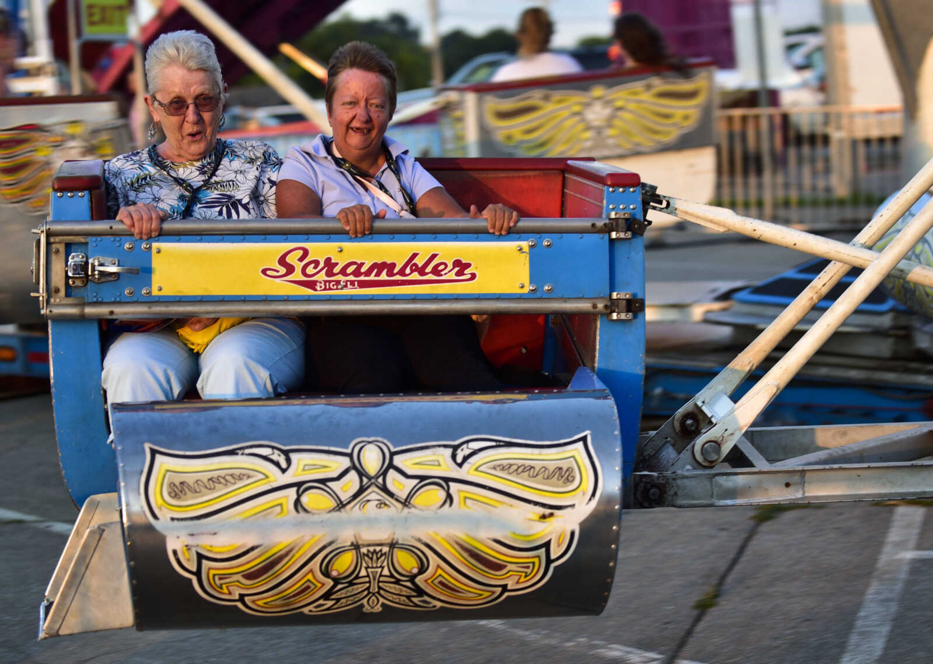 Joyce Darbar, left, and Shelli Brooks sit together on the "Scrambler" ride during Homecomers on Friday, July 28, 2018 in Jackson.