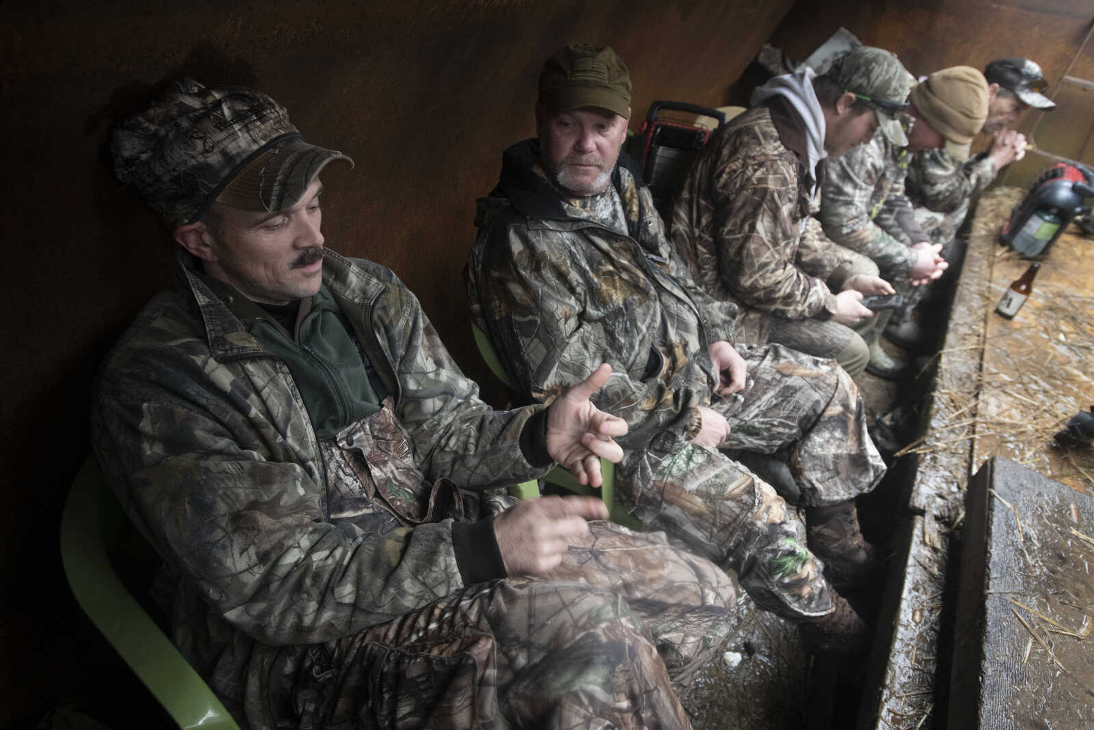 Active duty Air Force member Andrew Shanahorn, left, converses with Army veteran Paul Jubinville, facing Shanahorn, during a snow geese hunt Saturday, March 14, 2020, in Ware, Illinois.