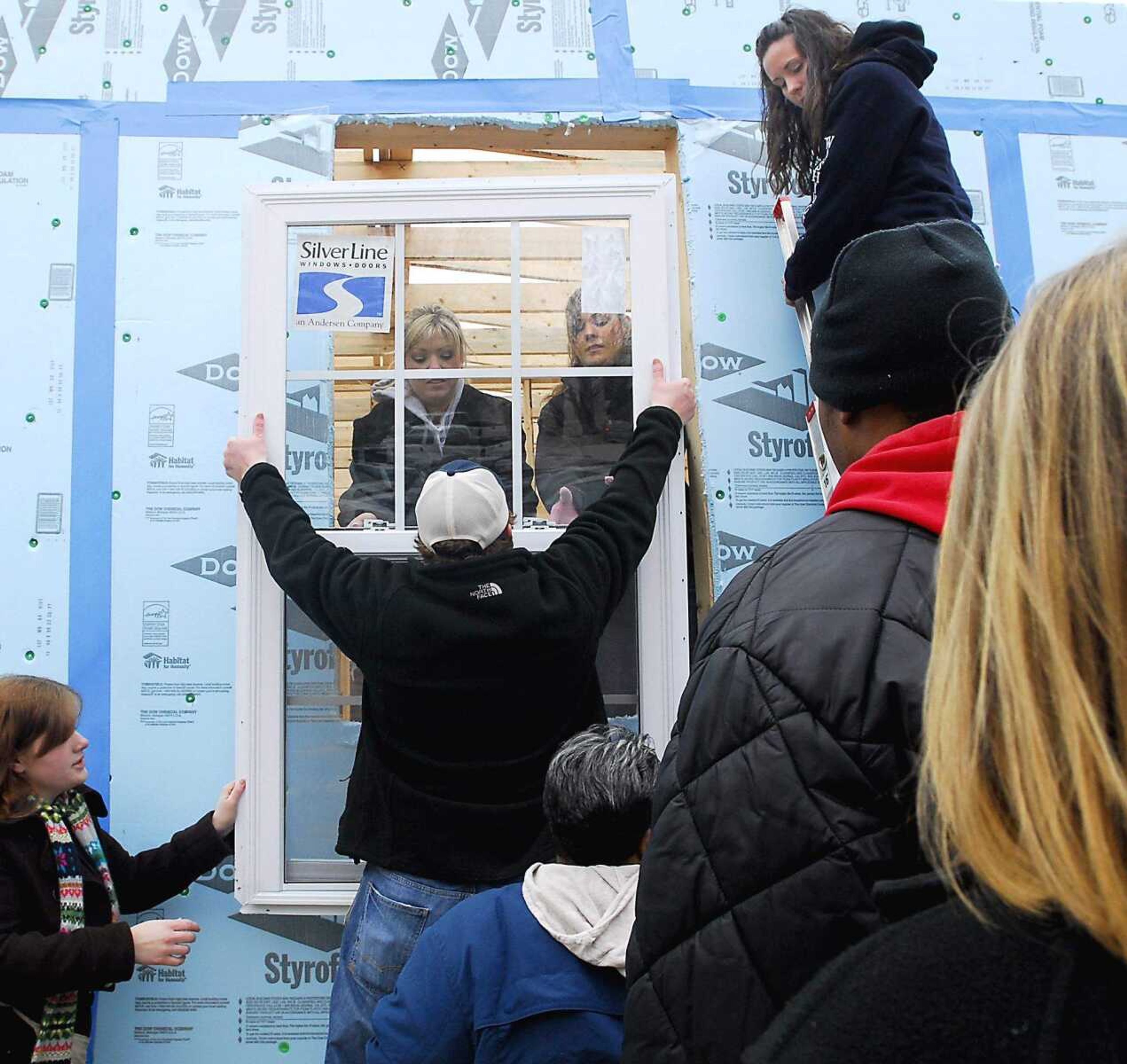 KIT DOYLE ~ kdoyle@semissourian.com
Volunteers install a window Thursday, March 12, 2009, at the Habitat for Humanity home being constructed on Southeast Missouri State's campus.