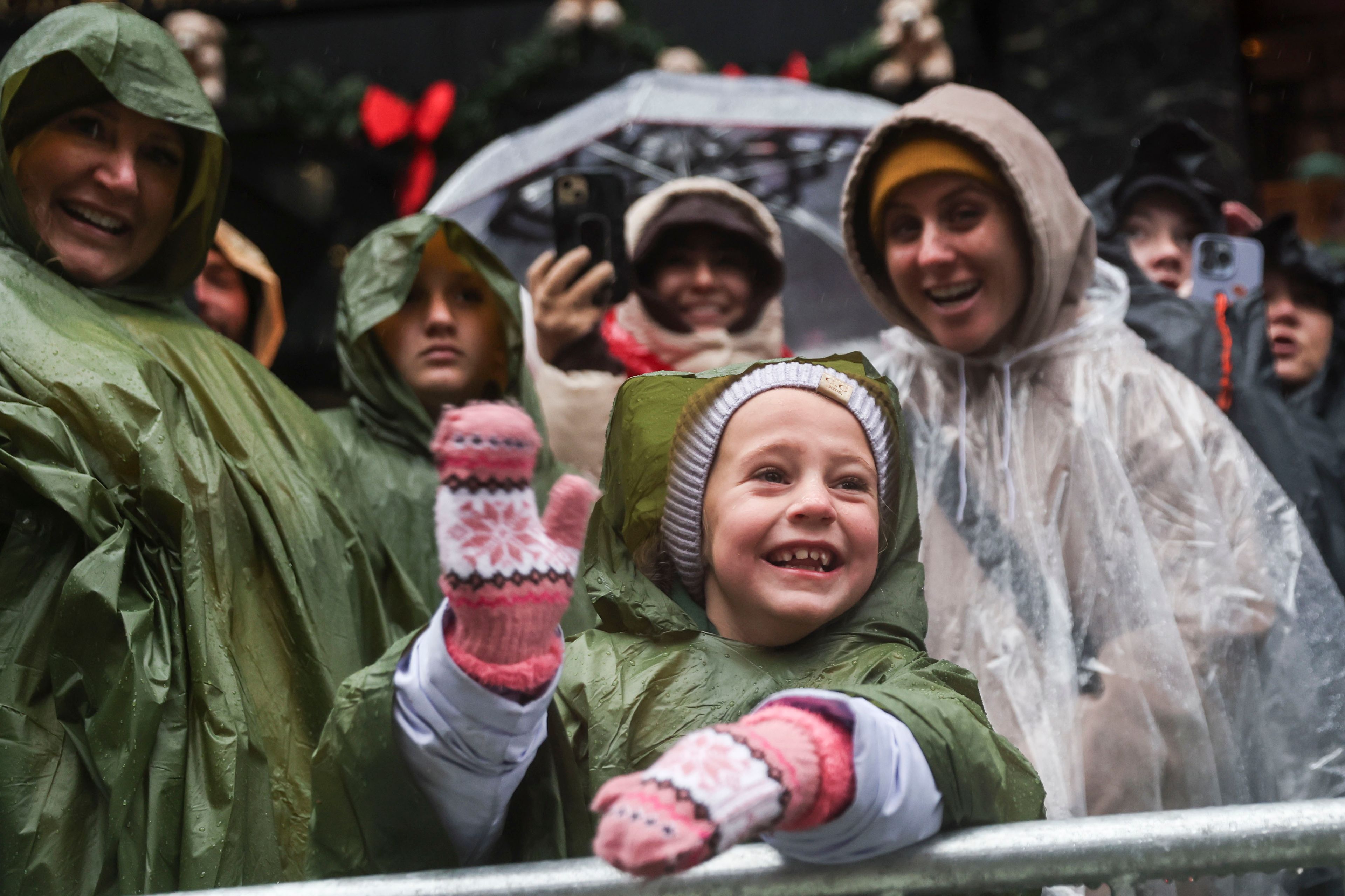 Chandler Butler, 6, waves at floats during the Macy's Thanksgiving Day Parade, Thursday, Nov. 28, 2024, in New York. (AP Photo/Heather Khalifa)