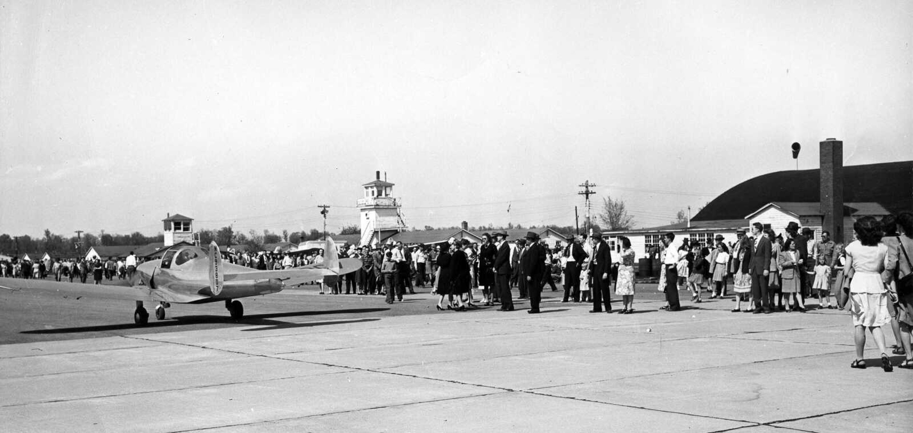 A portion of the huge crowd at Harris Field watches a small private plane takes off after the air show in April 1947. 